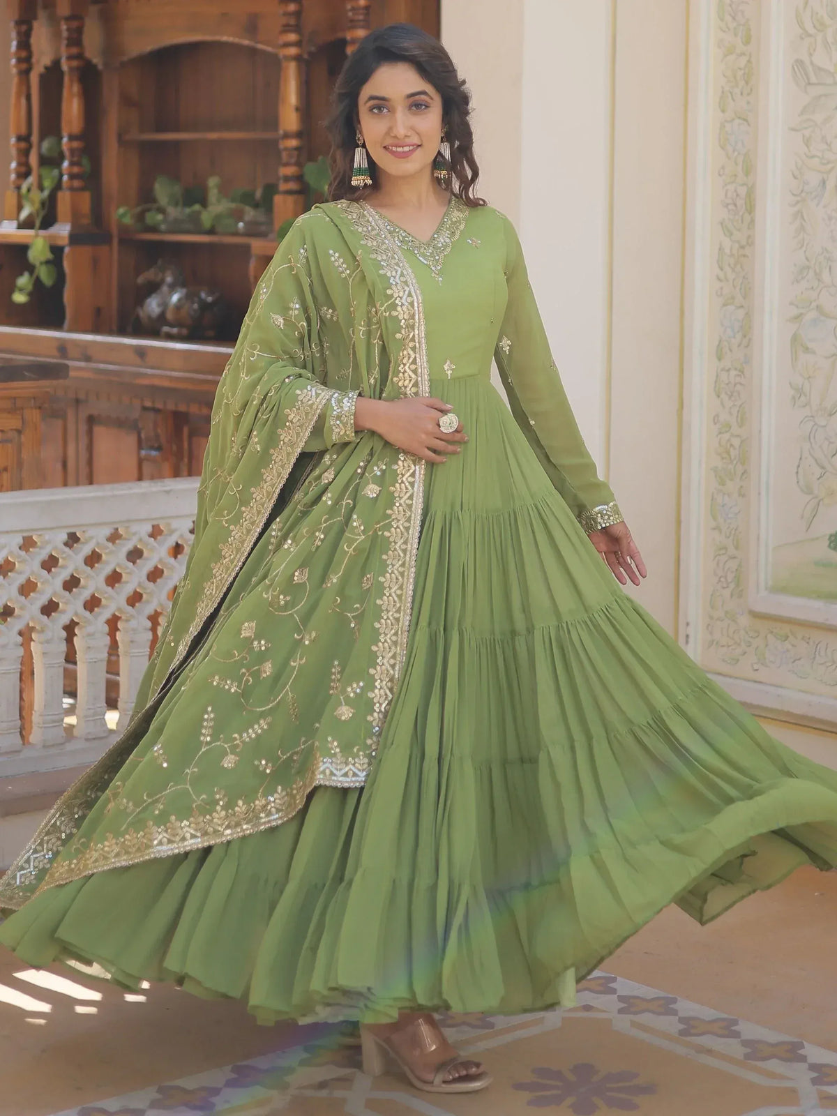 Green embroidered anarkali gown with gold detailing, perfect for Indian ethnic wear and festive occasions.