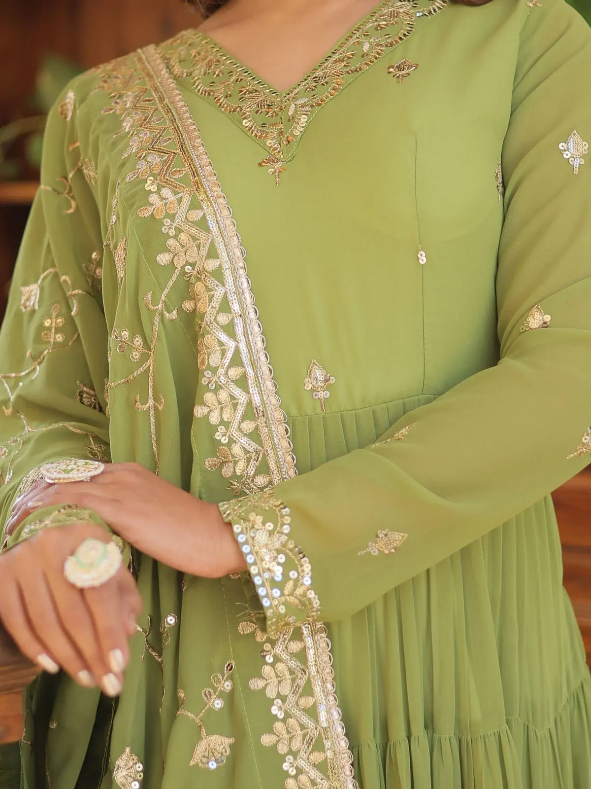 Olive green ethnic gown with gold embroidery and sequin detailing, perfect for festive occasions.