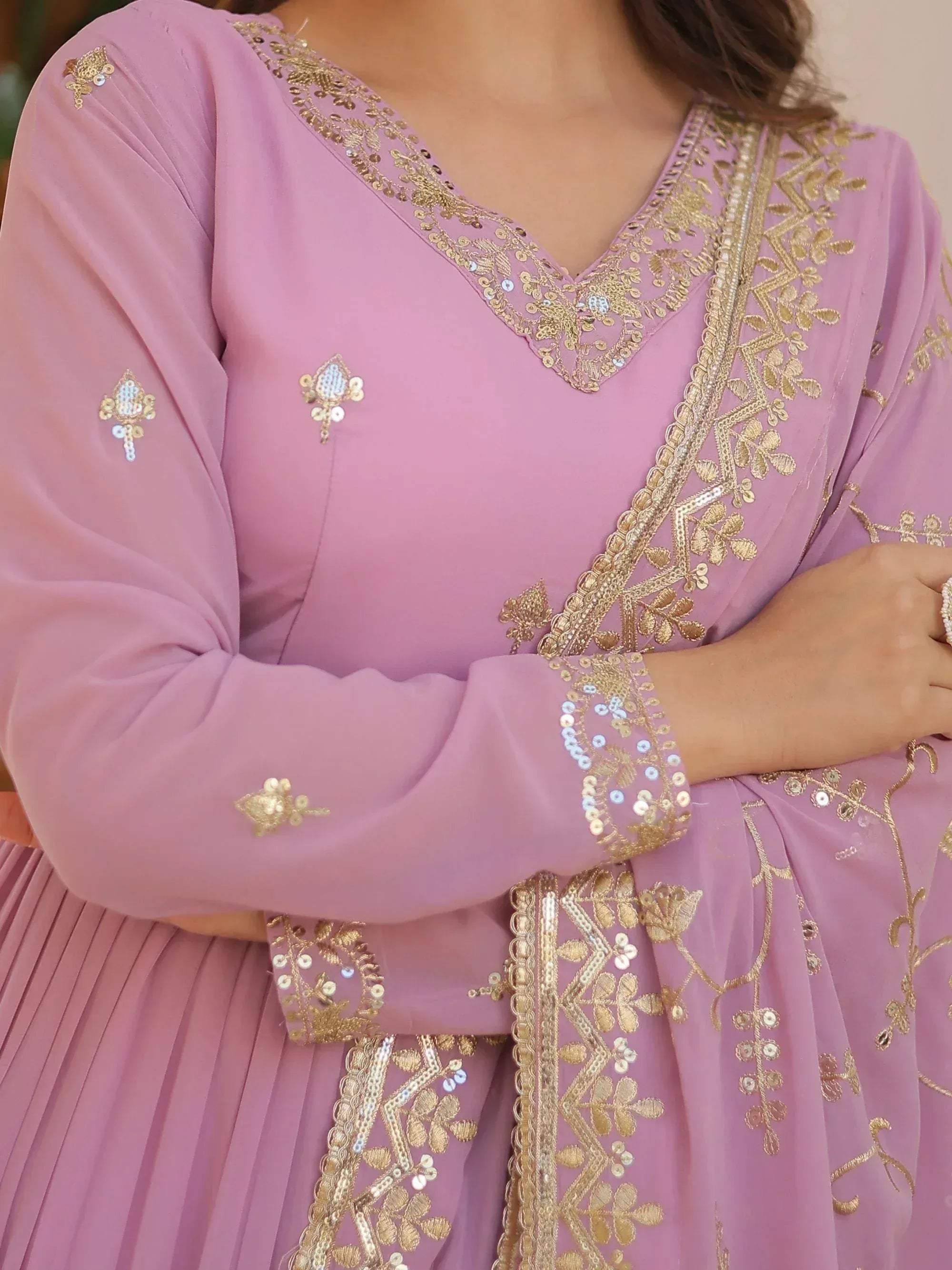 Pink ethnic gown with gold embroidery and sequin detailing, perfect for Indian festive wear