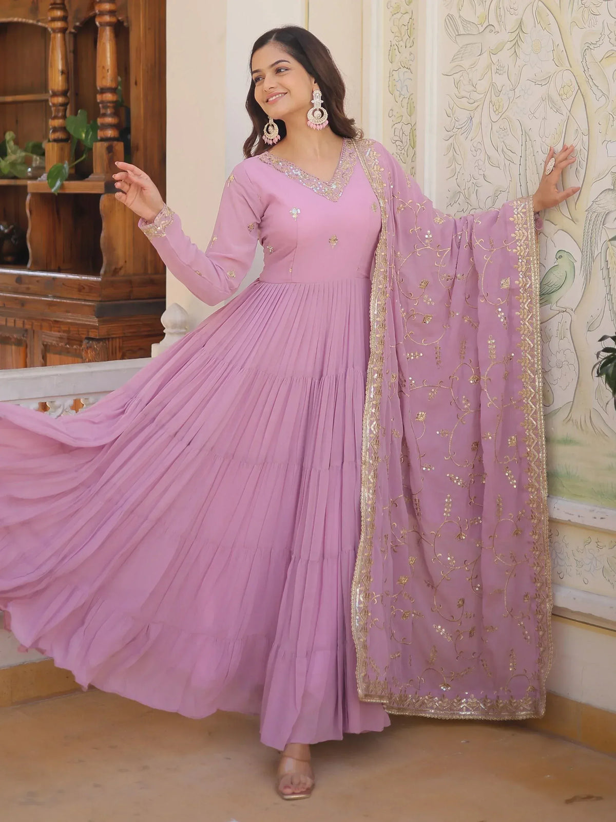 Elegant lavender ethnic gown with gold embroidery and pleated skirt, perfect for Indian occasions