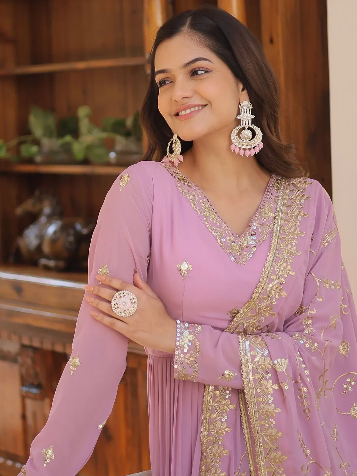 Elegant lavender ethnic gown with gold embroidery, perfect for Indian occasions and festivals.