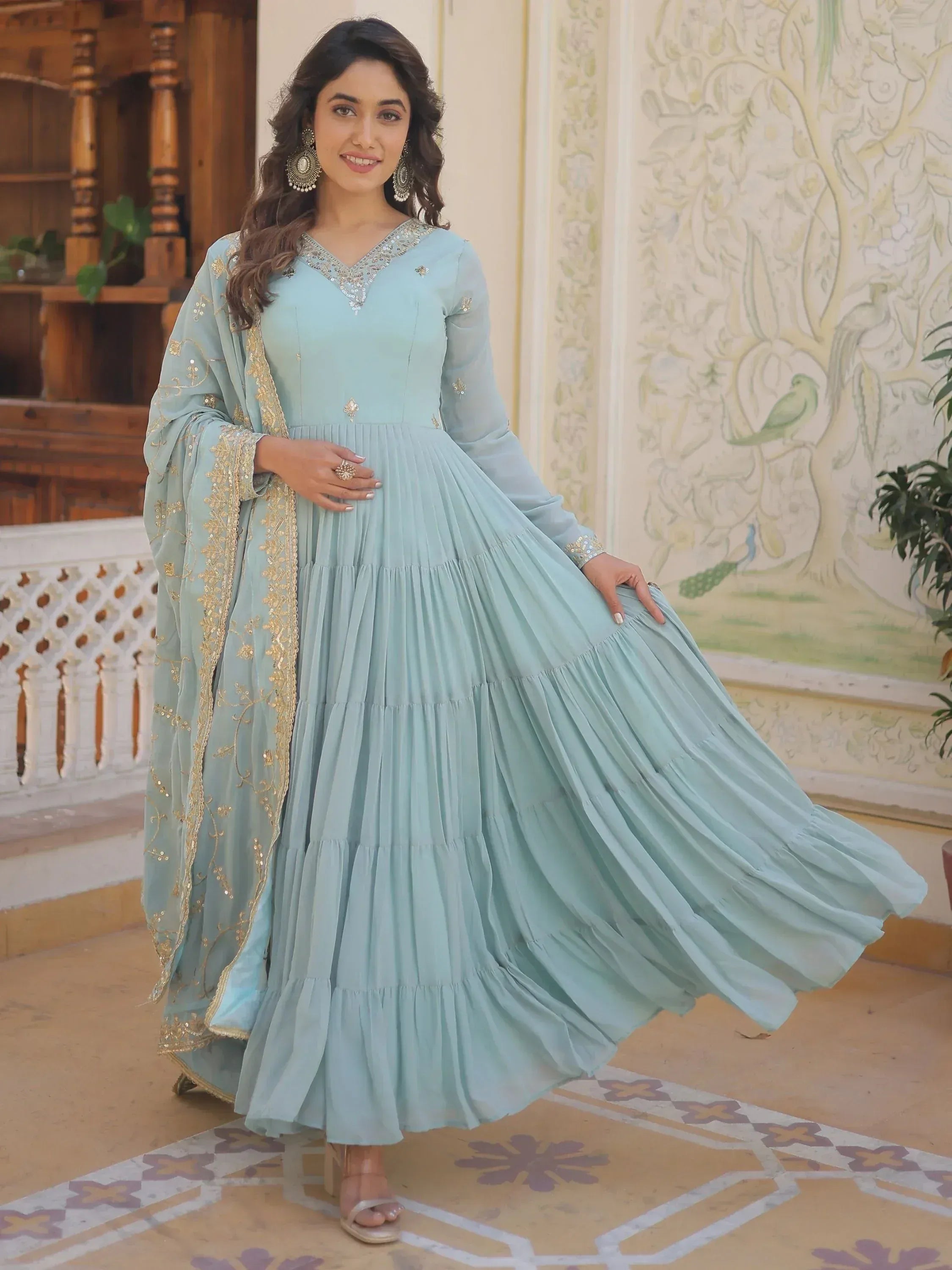 Light blue ethnic gown with gold embroidery and pleated skirt, perfect for Indian occasions