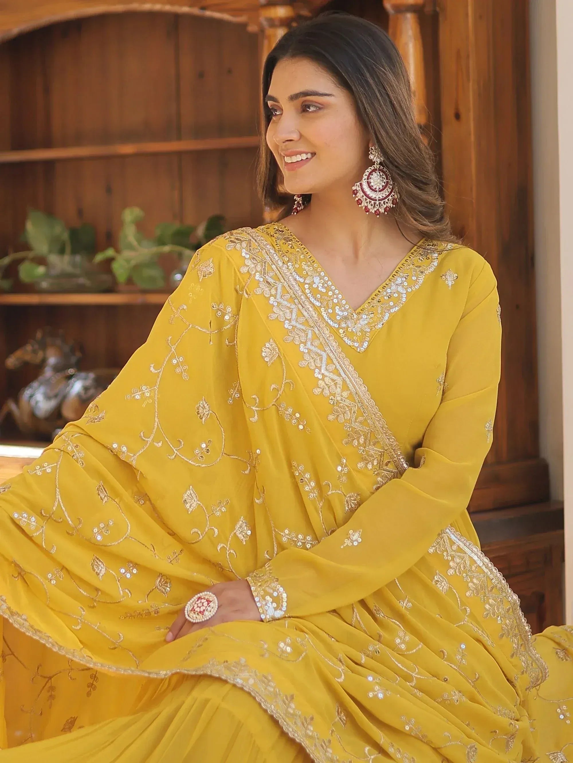 Yellow embroidered ethnic gown with gold detailing, perfect for Indian festive occasions
