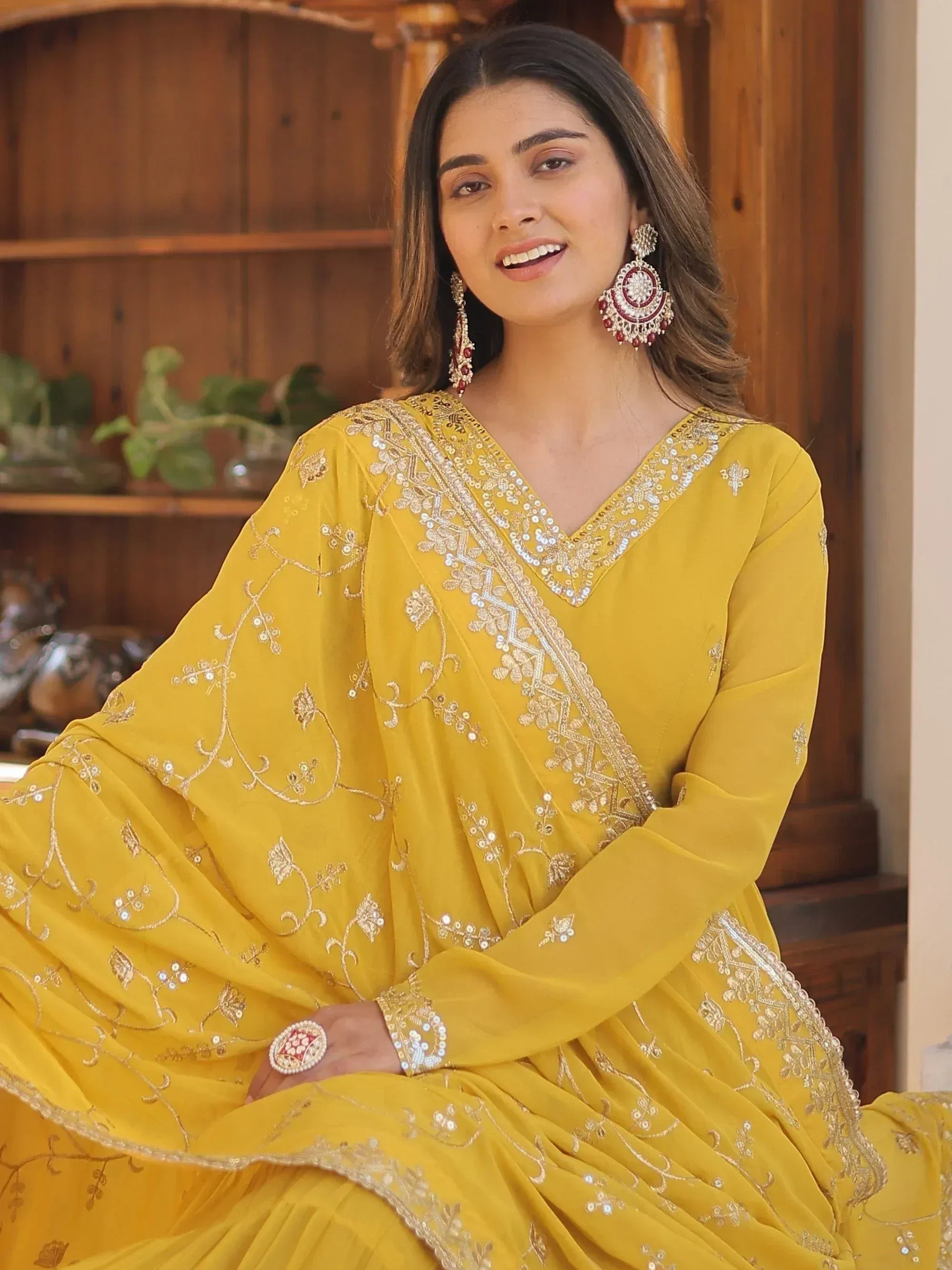 Yellow embroidered ethnic gown with gold detailing, perfect for Indian occasions and festive wear.