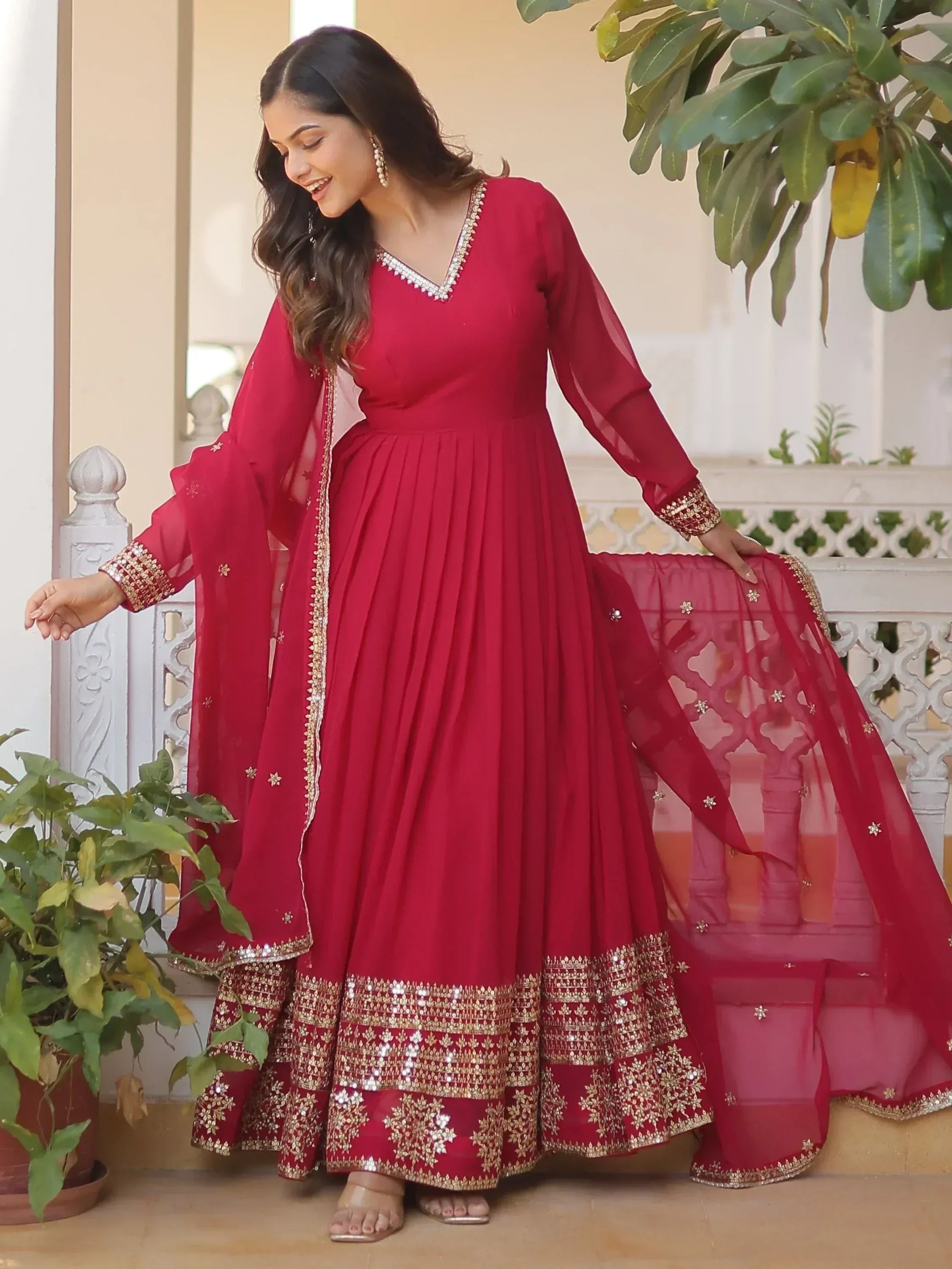 Red ethnic anarkali gown with gold embroidery and sheer dupatta, perfect for Indian weddings and festivals