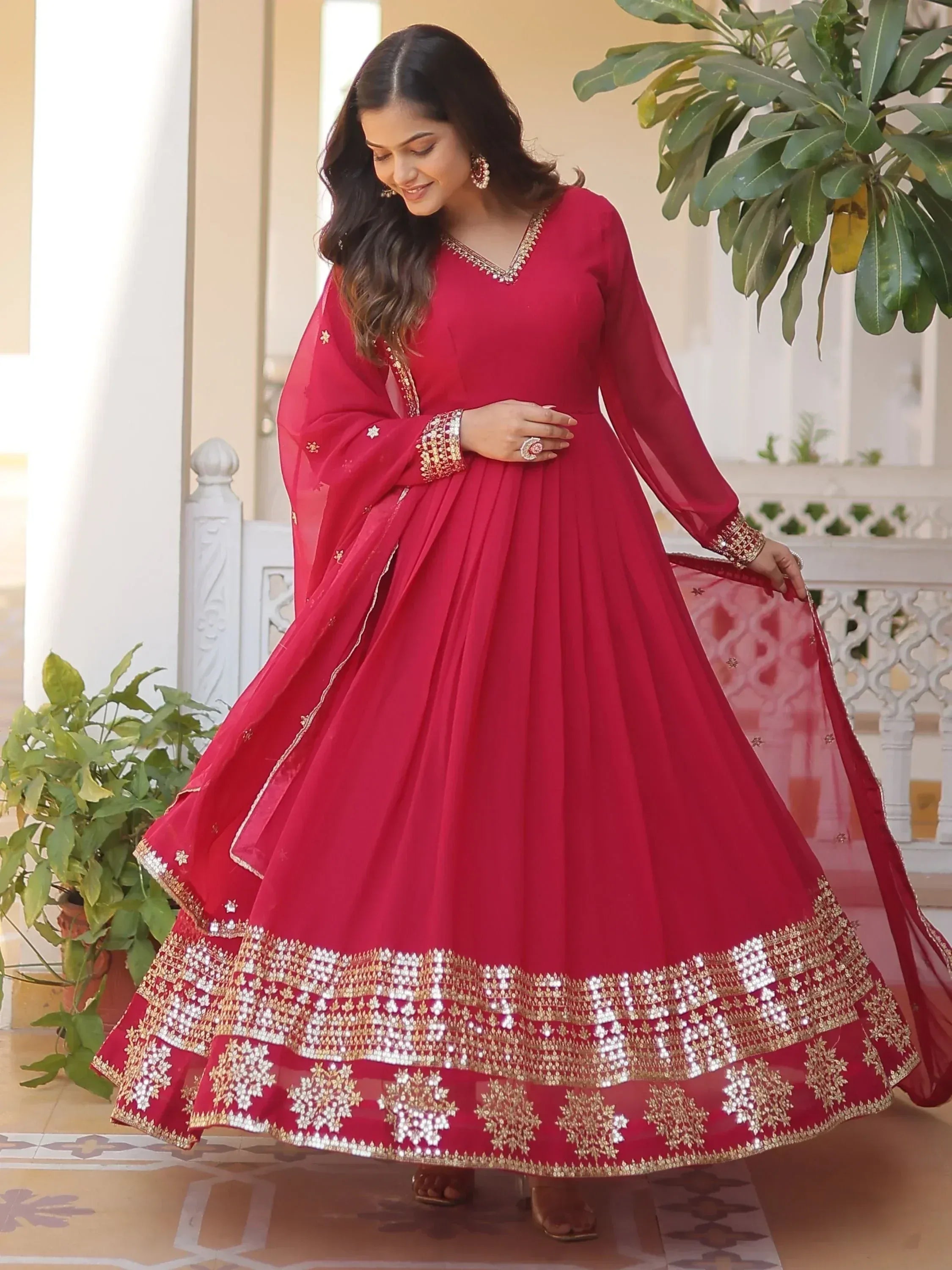 Red ethnic anarkali gown with gold embroidery, perfect for Indian weddings and festive occasions