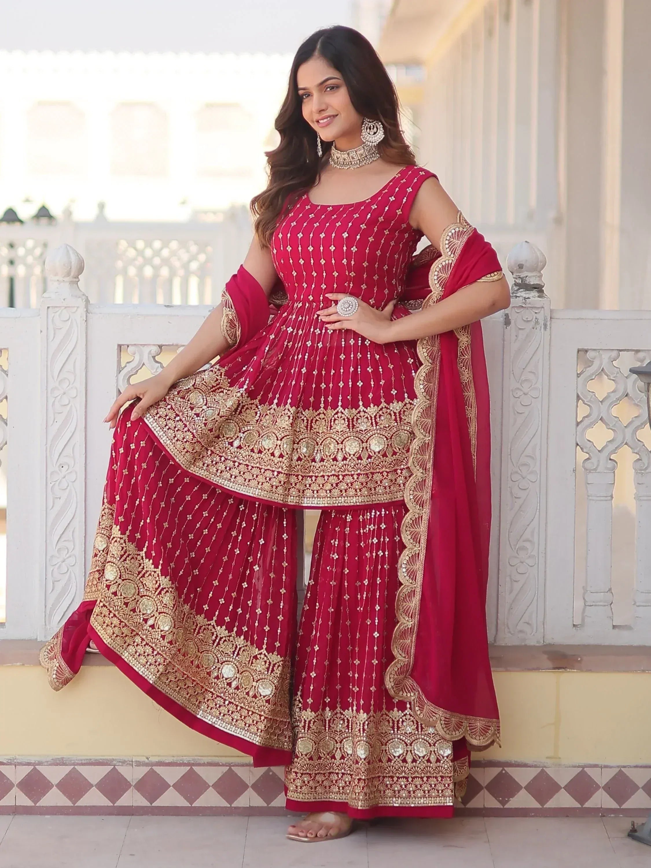 Red ethnic sharara suit with gold embroidery, perfect for Indian weddings and festive occasions