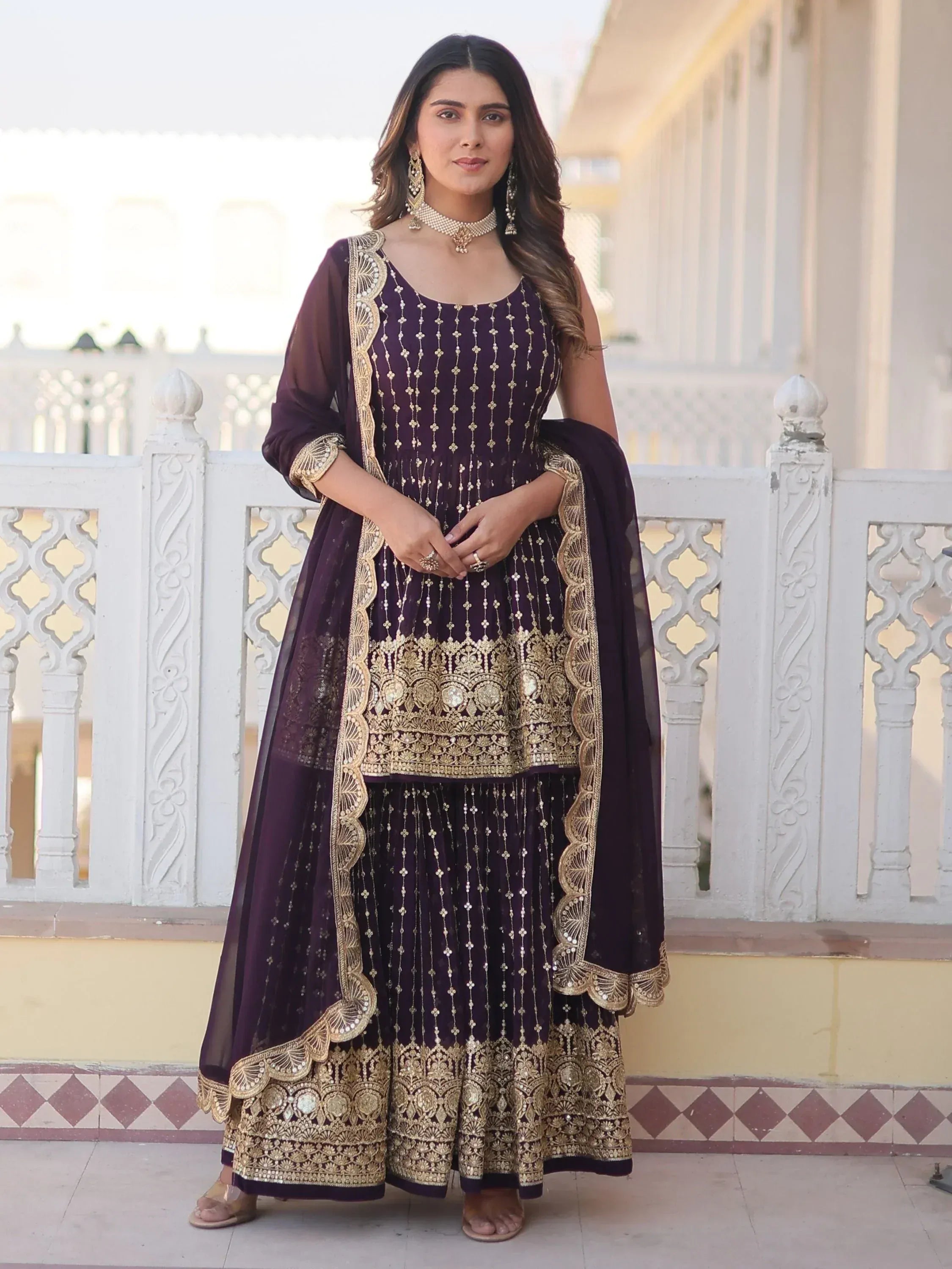 Elegant purple ethnic gown with gold embroidery, perfect for Indian weddings and festive occasions.