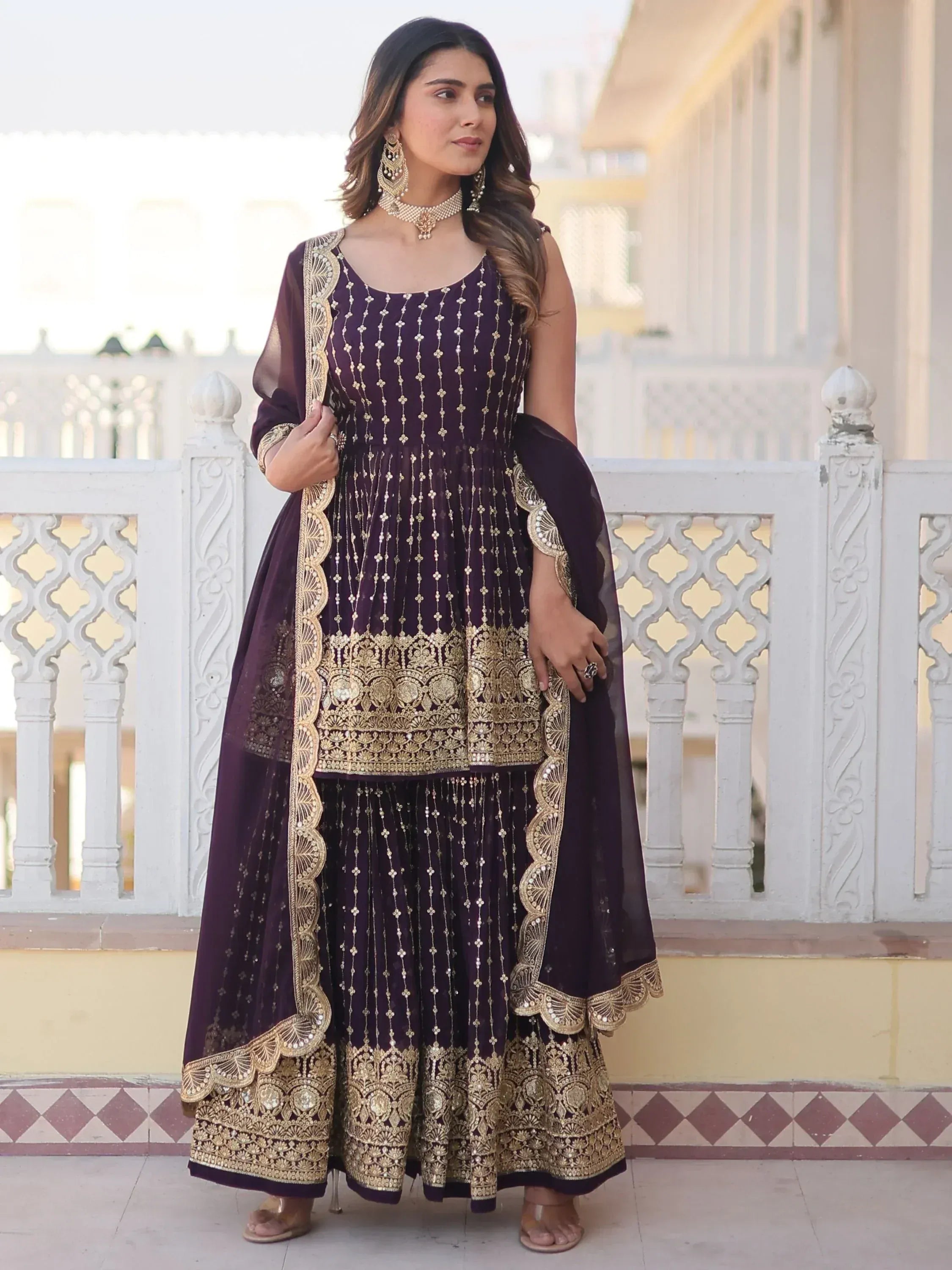Purple ethnic gown with gold embroidery, perfect for Indian weddings or festive occasions.