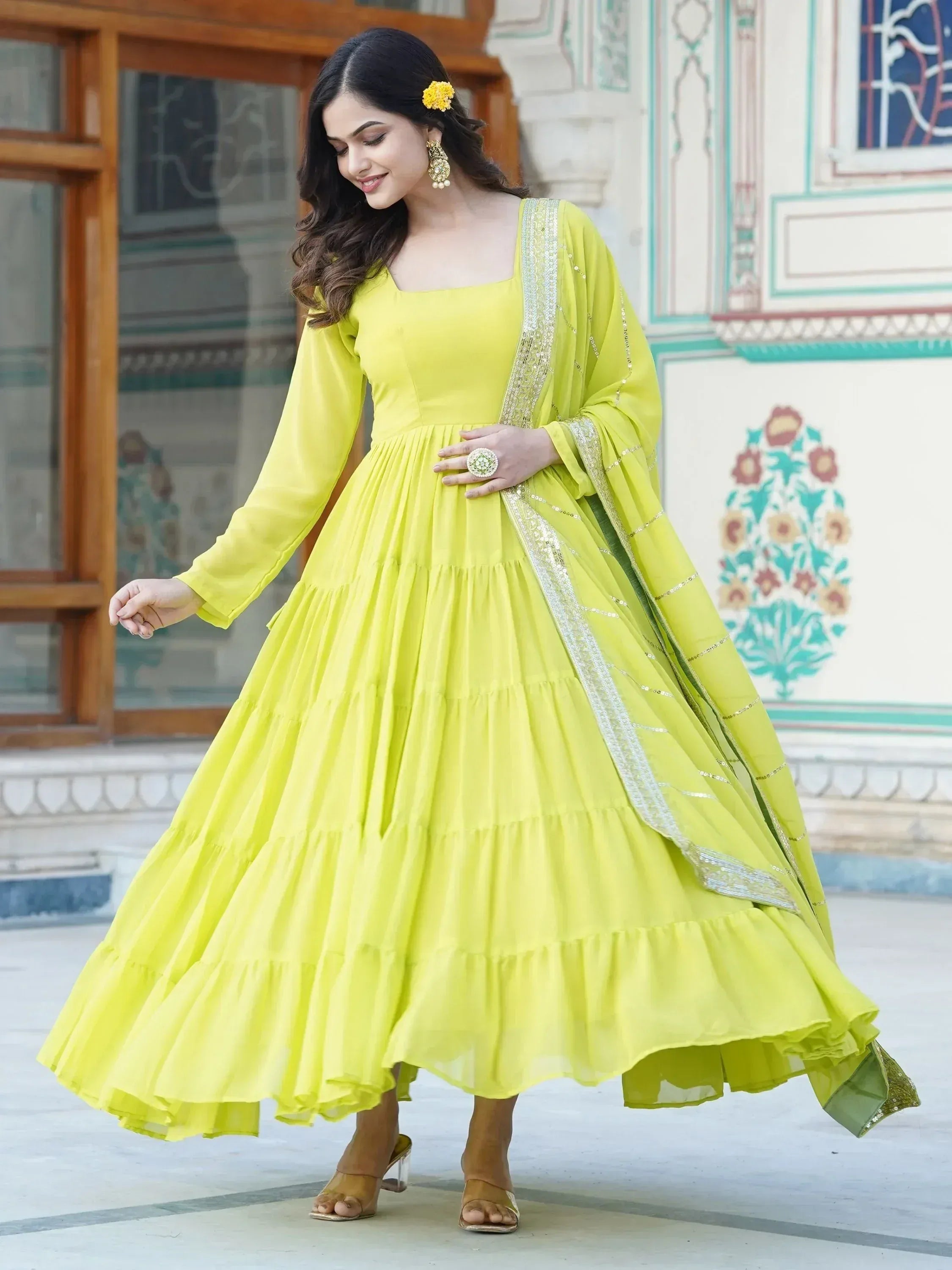 Vibrant yellow tiered ethnic gown with sequin dupatta, perfect for Indian festive occasions and celebrations.