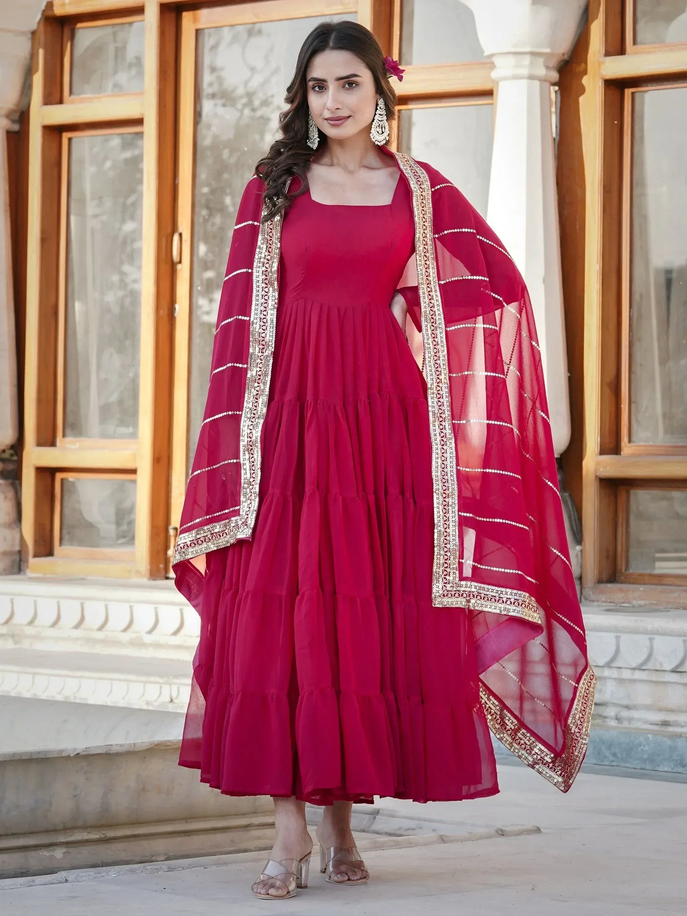Elegant maroon tiered ethnic gown with gold-trimmed dupatta for festive occasions