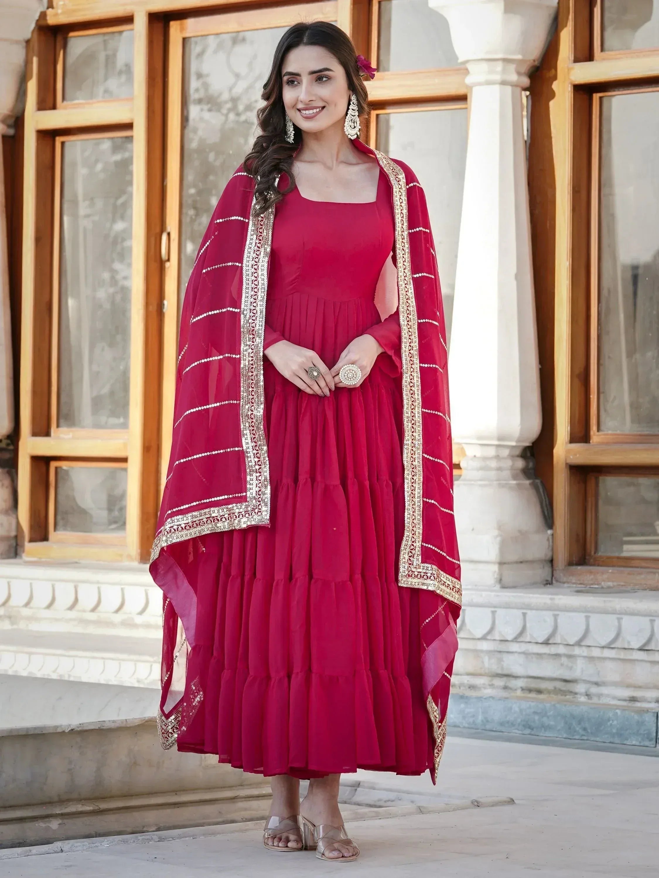 Elegant red ethnic gown with gold embroidery and matching dupatta for festive occasions
