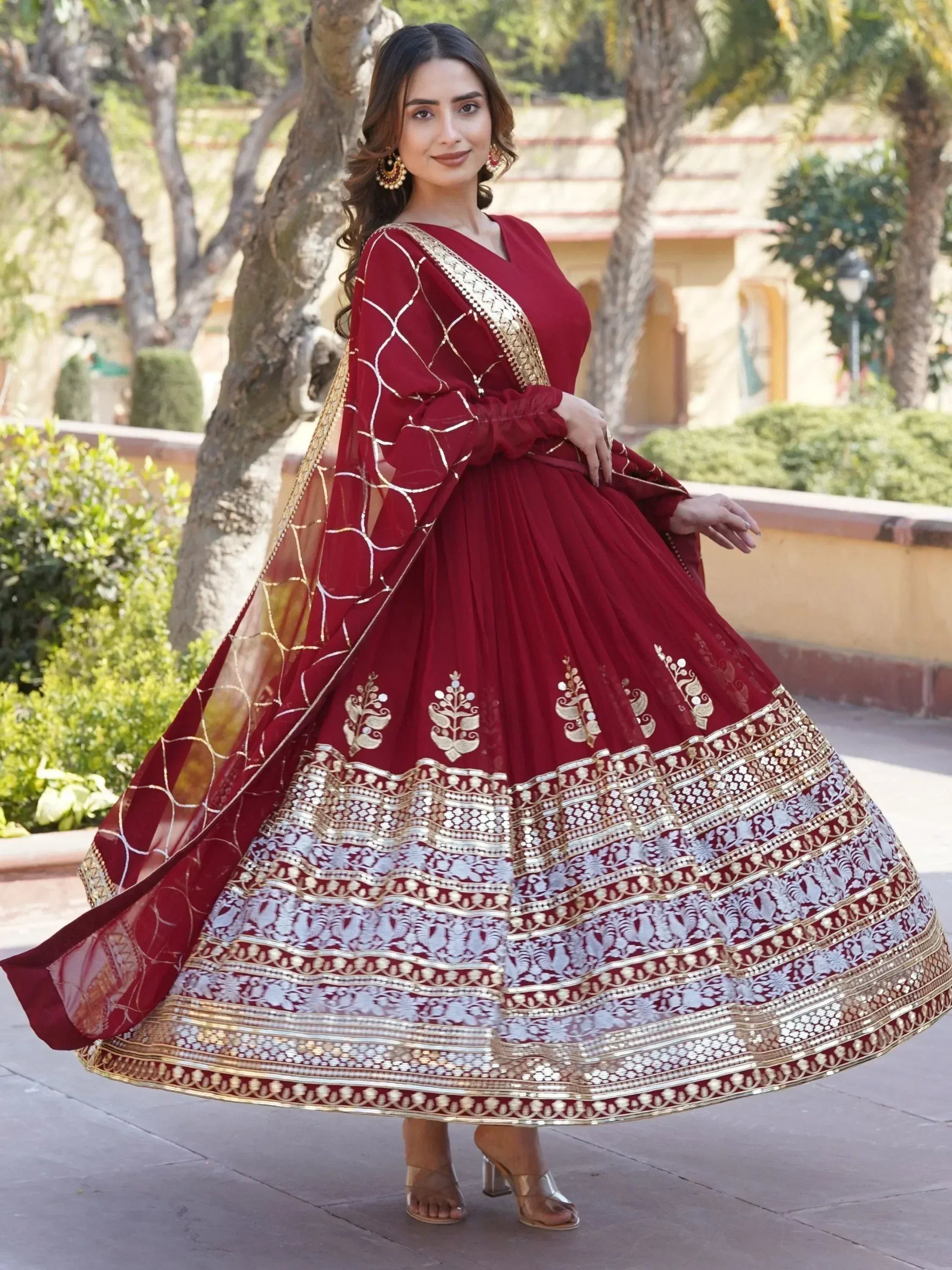 Maroon designer lehenga choli with gold embroidery and mirror work, perfect for Indian ethnic wear occasions