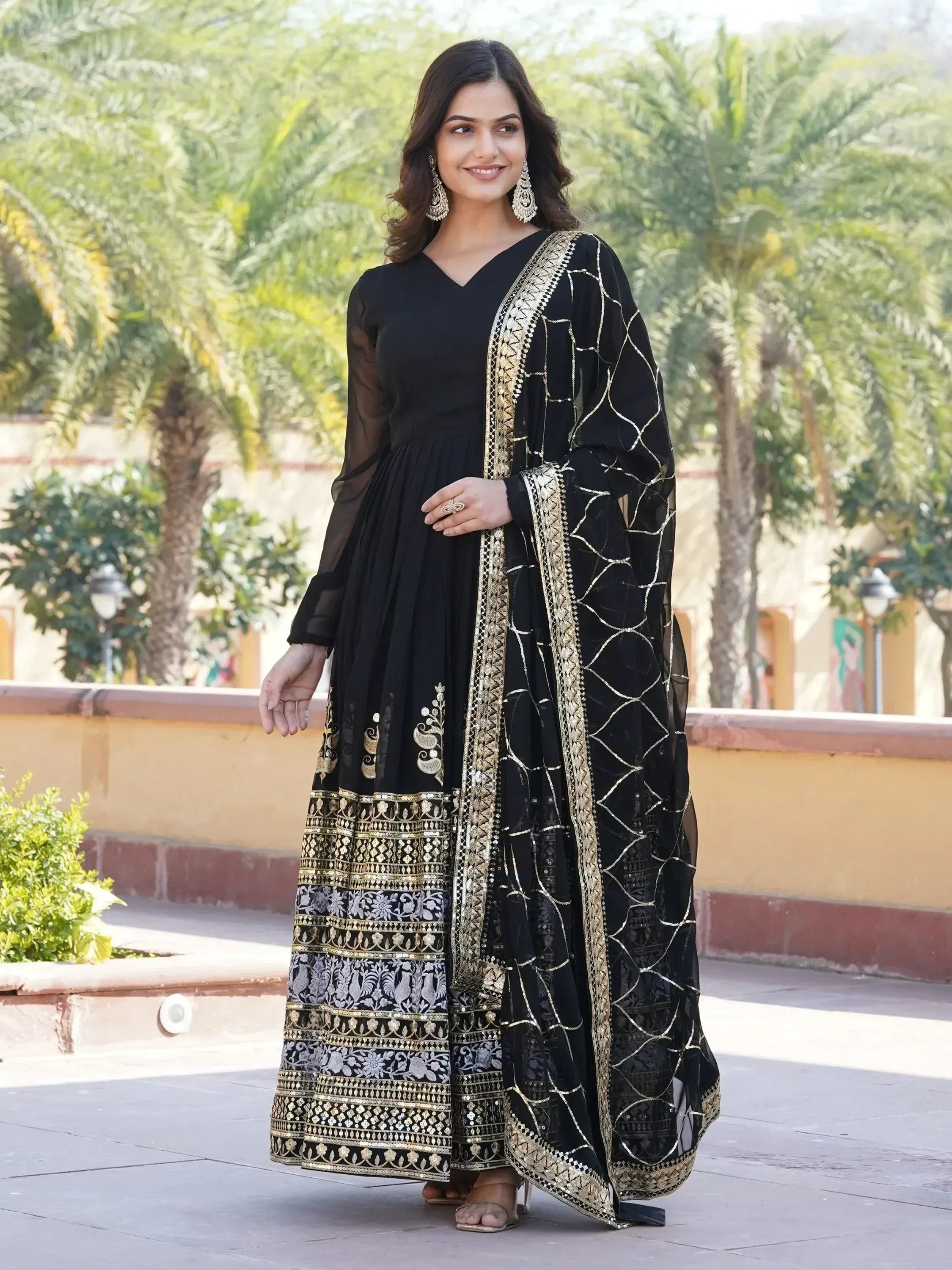 Black ethnic gown with gold embroidery and sheer dupatta, perfect for Indian occasions