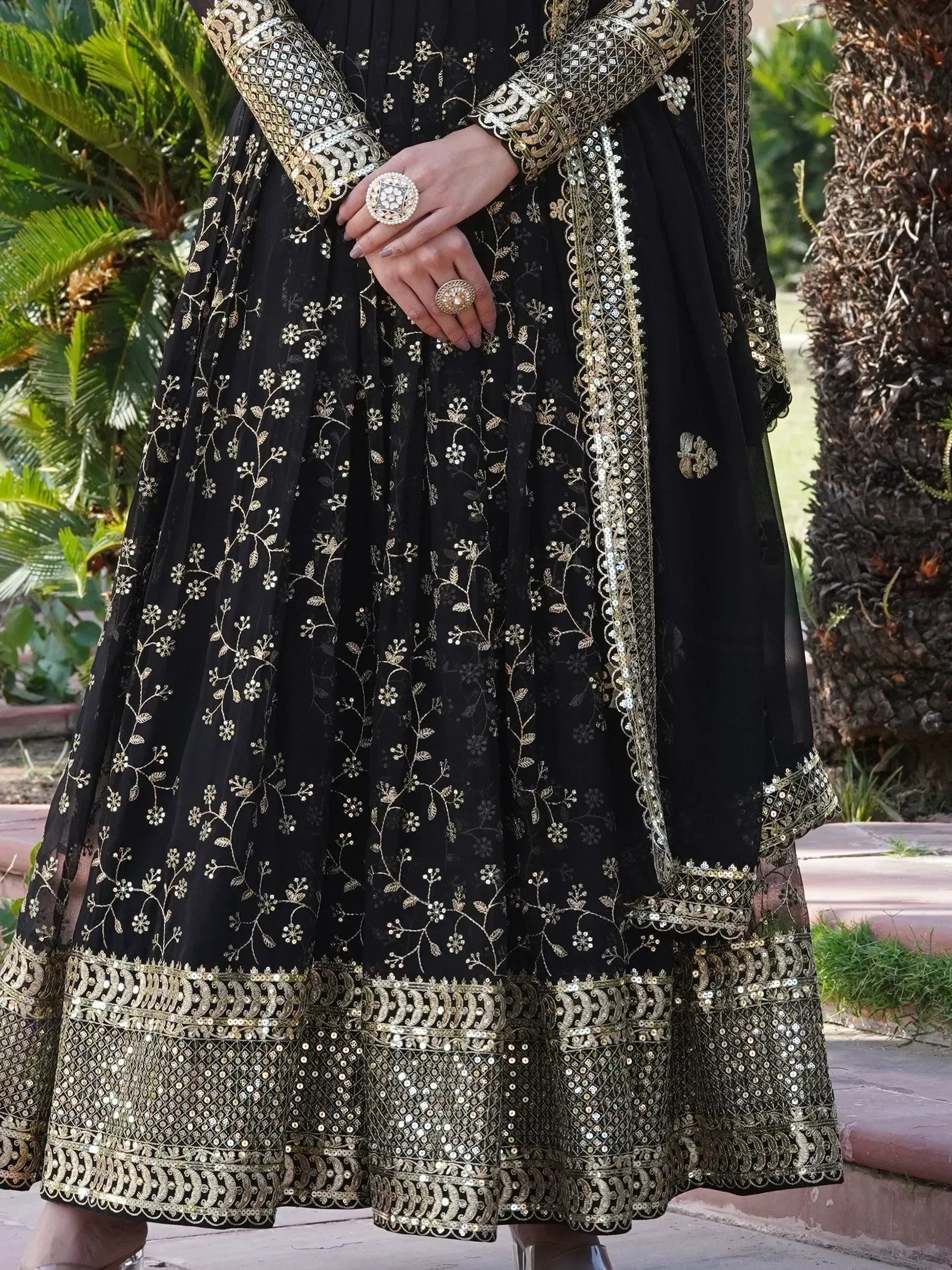 Black and gold embroidered lehenga choli with floral motifs and sequin detailing, perfect for Indian ethnic wear.