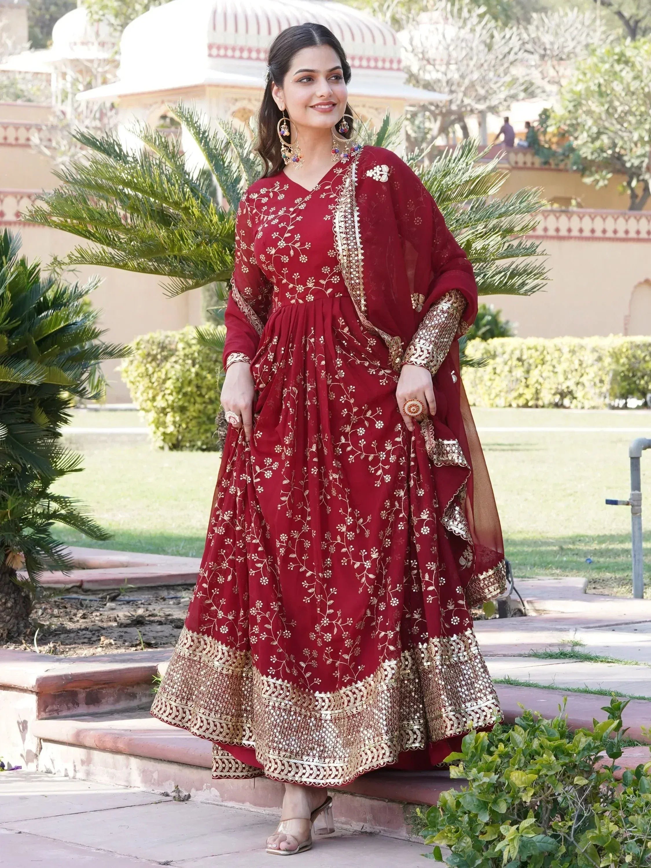 Maroon ethnic anarkali with gold floral embroidery and mirror work, perfect for Indian weddings or festivals