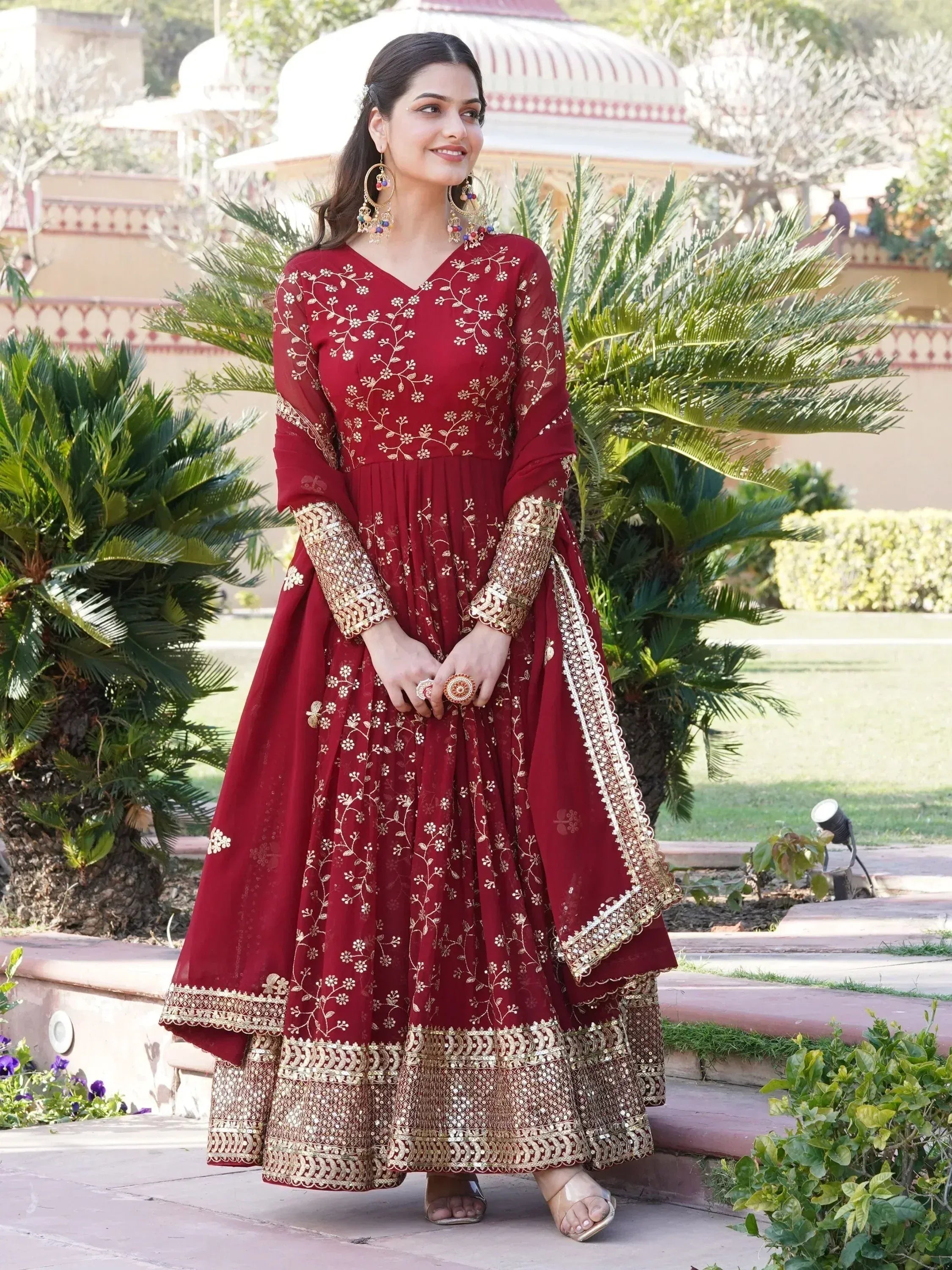 Elegant maroon ethnic gown with gold embroidery, perfect for Indian celebrations and events.