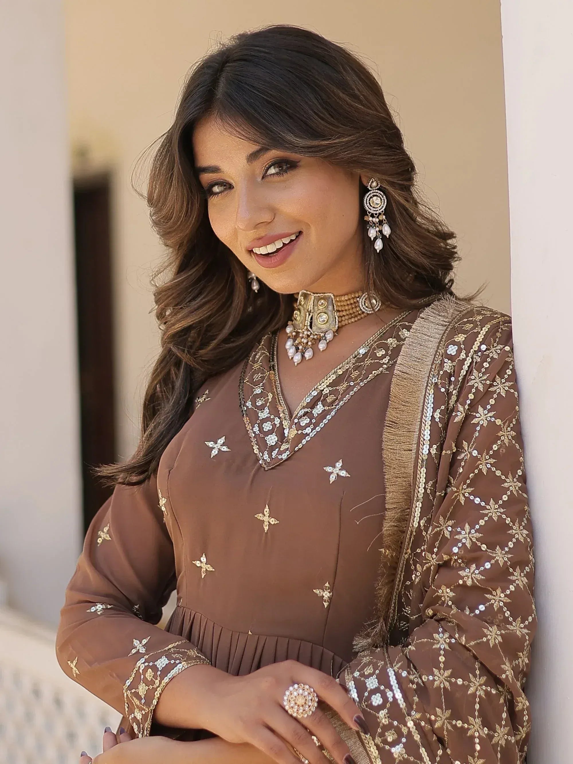 Elegant brown ethnic gown with gold embroidery and matching jewelry for Indian wear