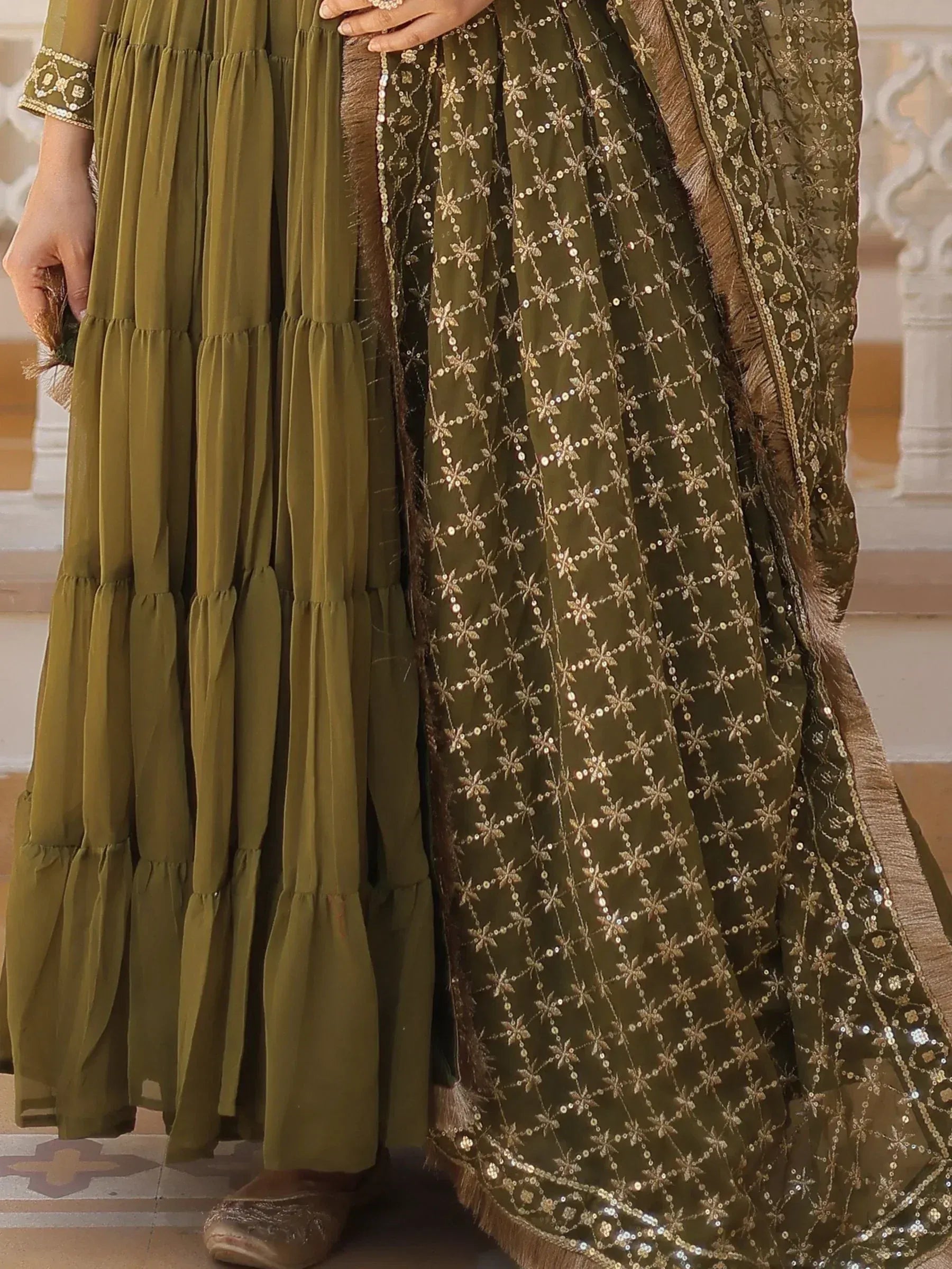 Olive green ethnic gown with gold sequin embroidery and tiered skirt, perfect for Indian festive occasions