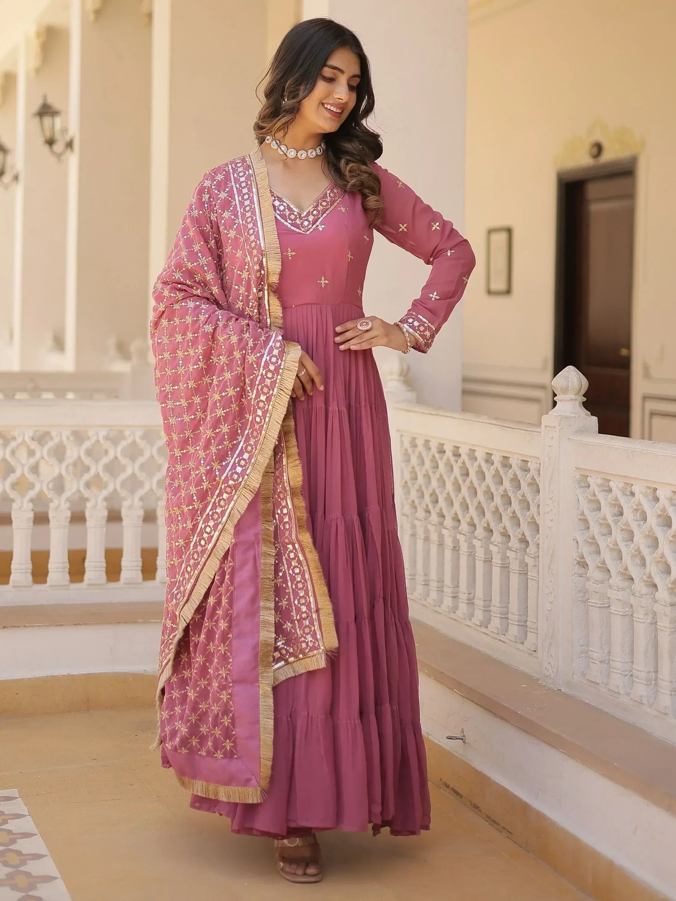 Pink ethnic gown with gold embroidery and matching dupatta, perfect for Indian occasions