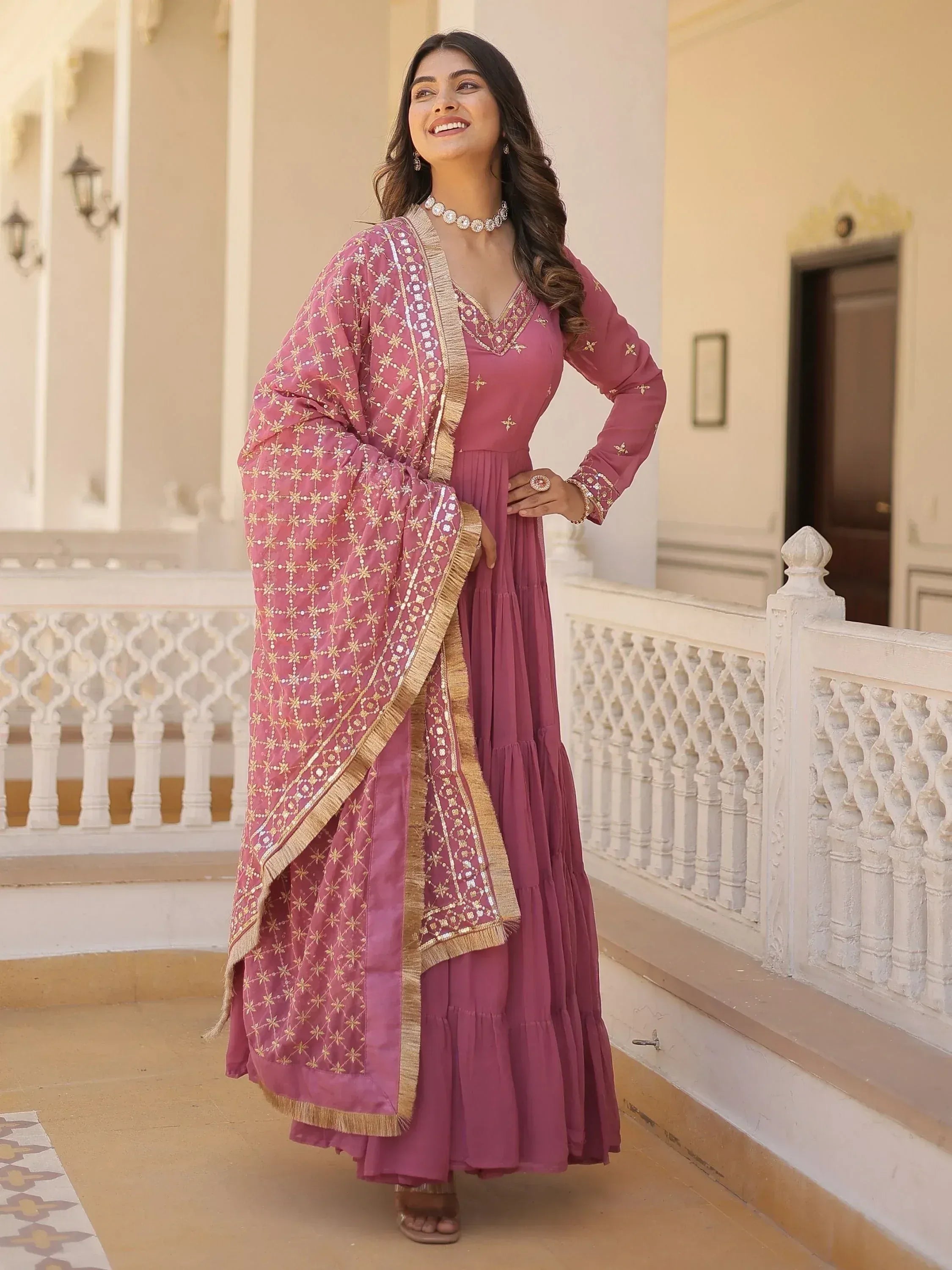 Pink embroidered ethnic gown with gold detailing, perfect for Indian occasions and festive wear.