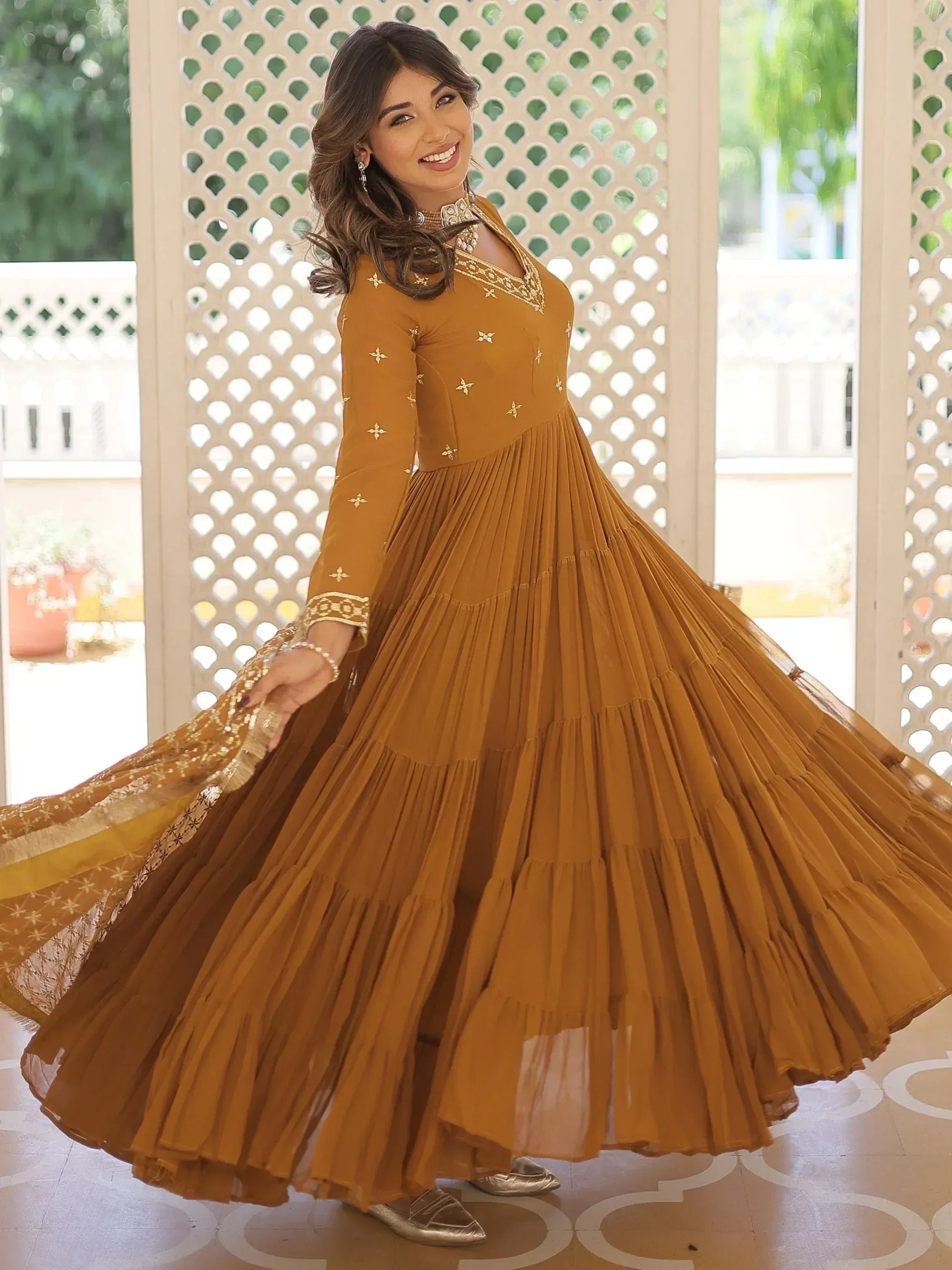Mustard ethnic gown with gold embroidery and pleated skirt, perfect for Indian occasions