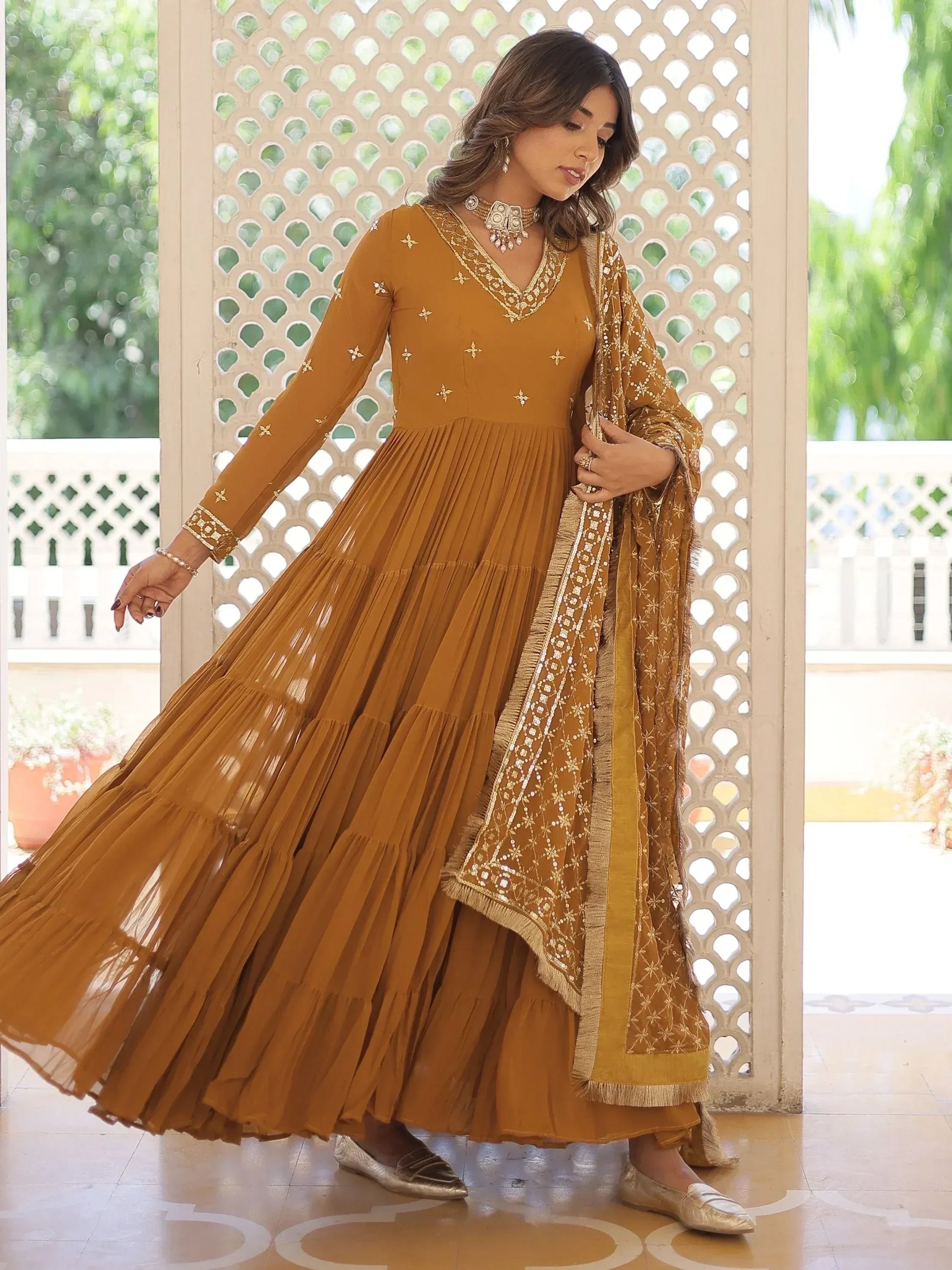 Mustard ethnic gown with gold embroidery, pleated skirt, and matching dupatta for Indian wear