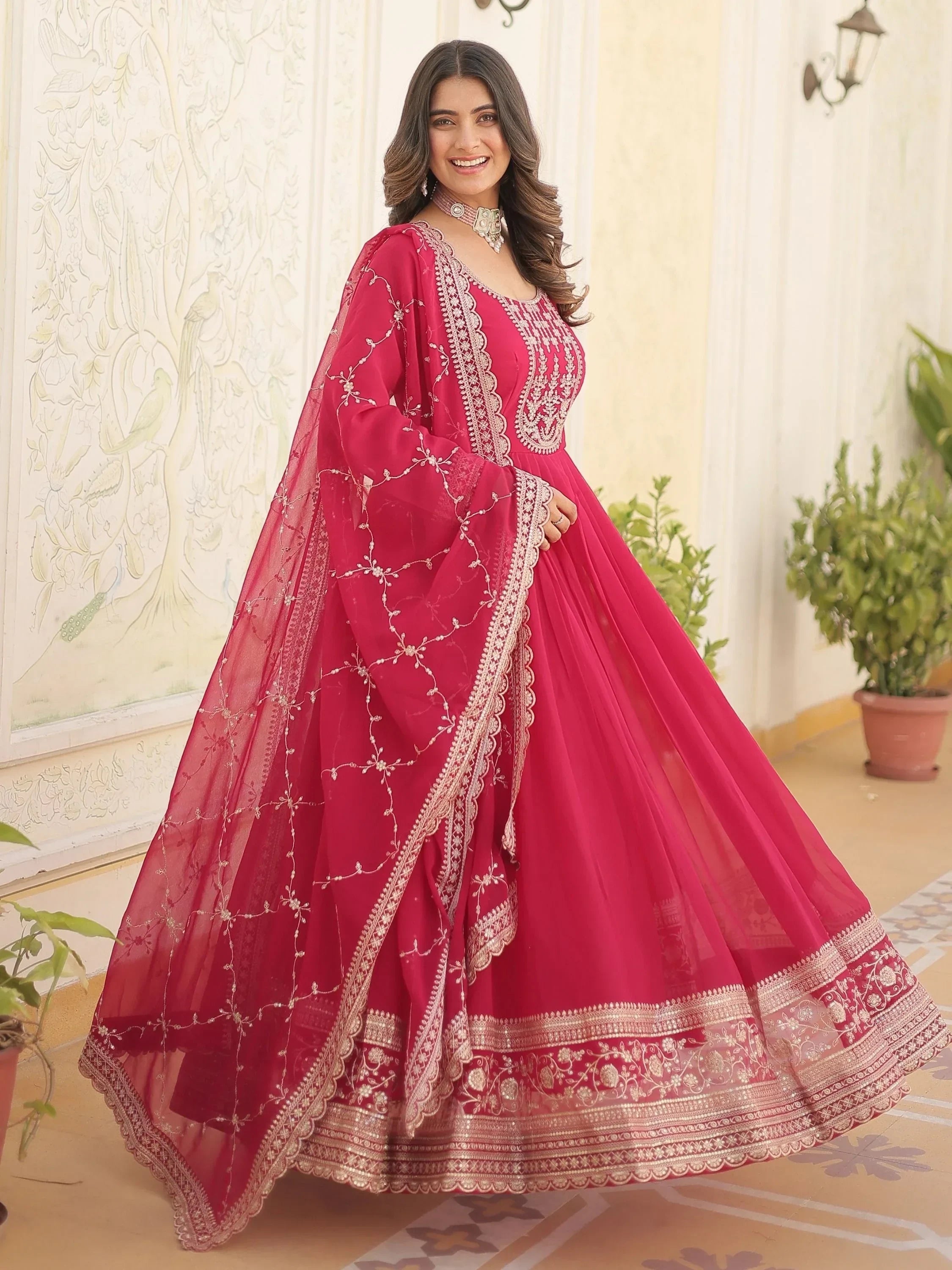 Woman wearing pink embroidered lehenga choli with dupatta, Indian ethnic wear