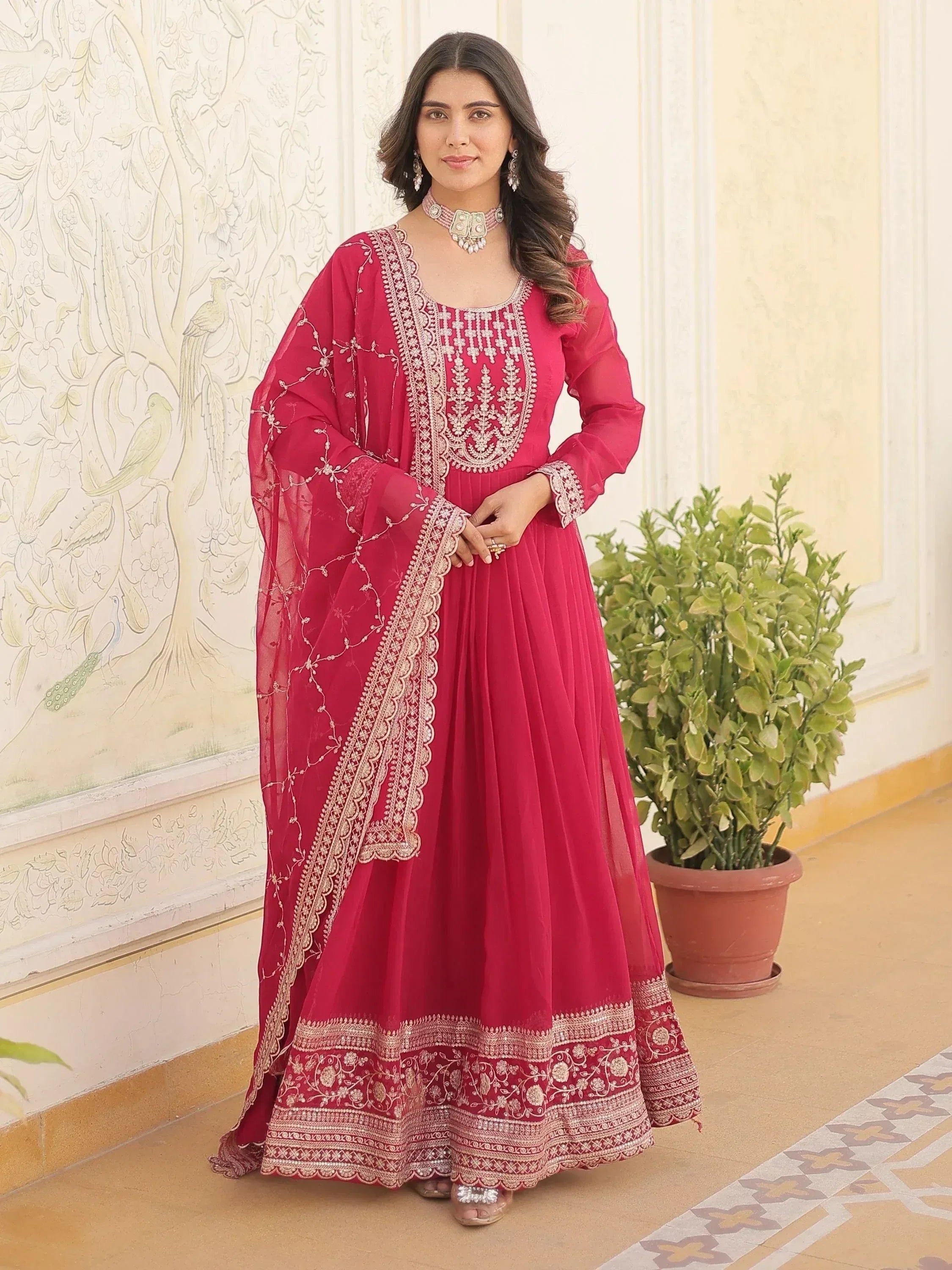 Elegant red ethnic anarkali suit with gold embroidery, perfect for Indian weddings and festive occasions.
