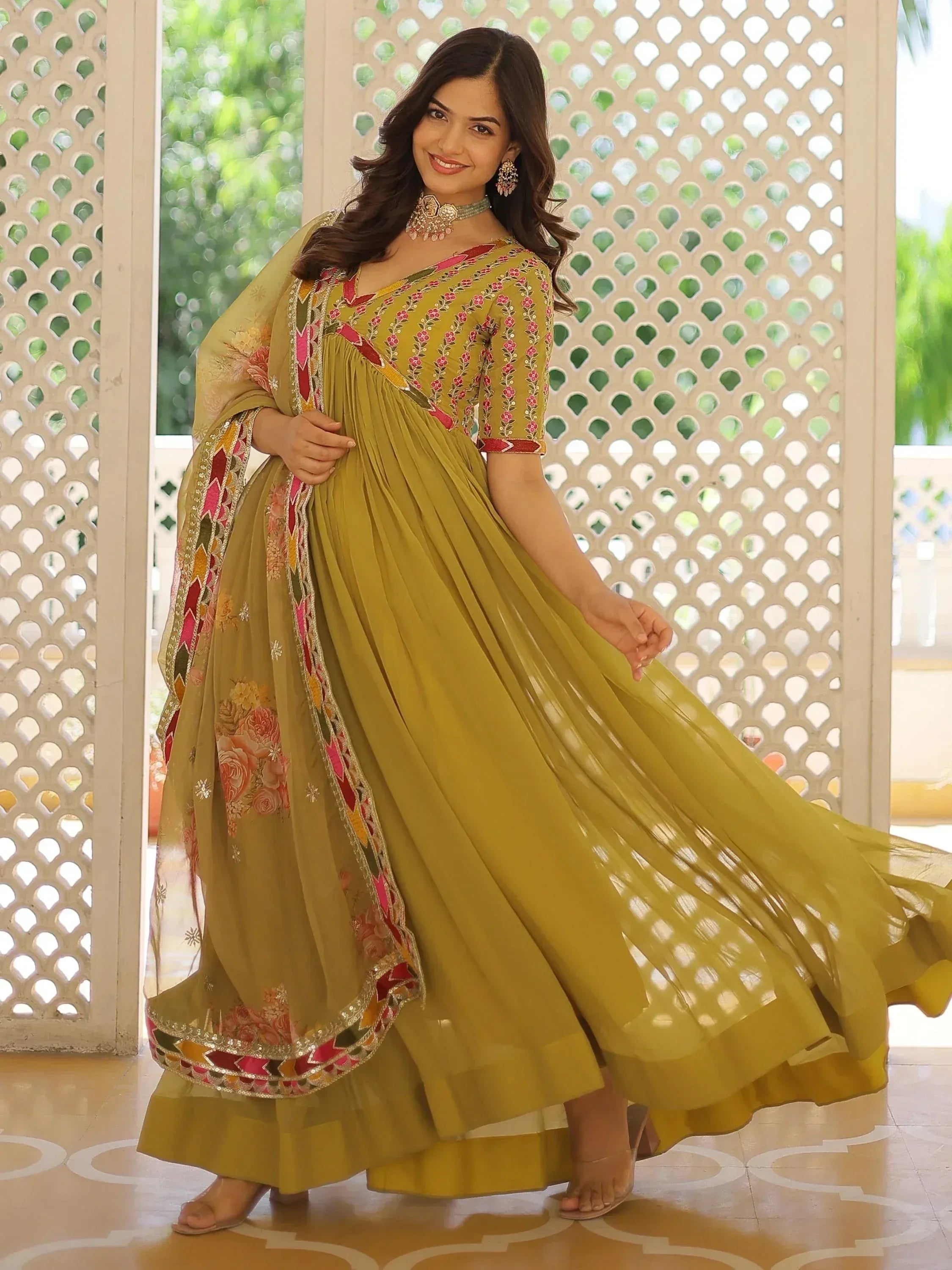 Mustard yellow ethnic gown with floral embroidery and pleated skirt, perfect for Indian occasions