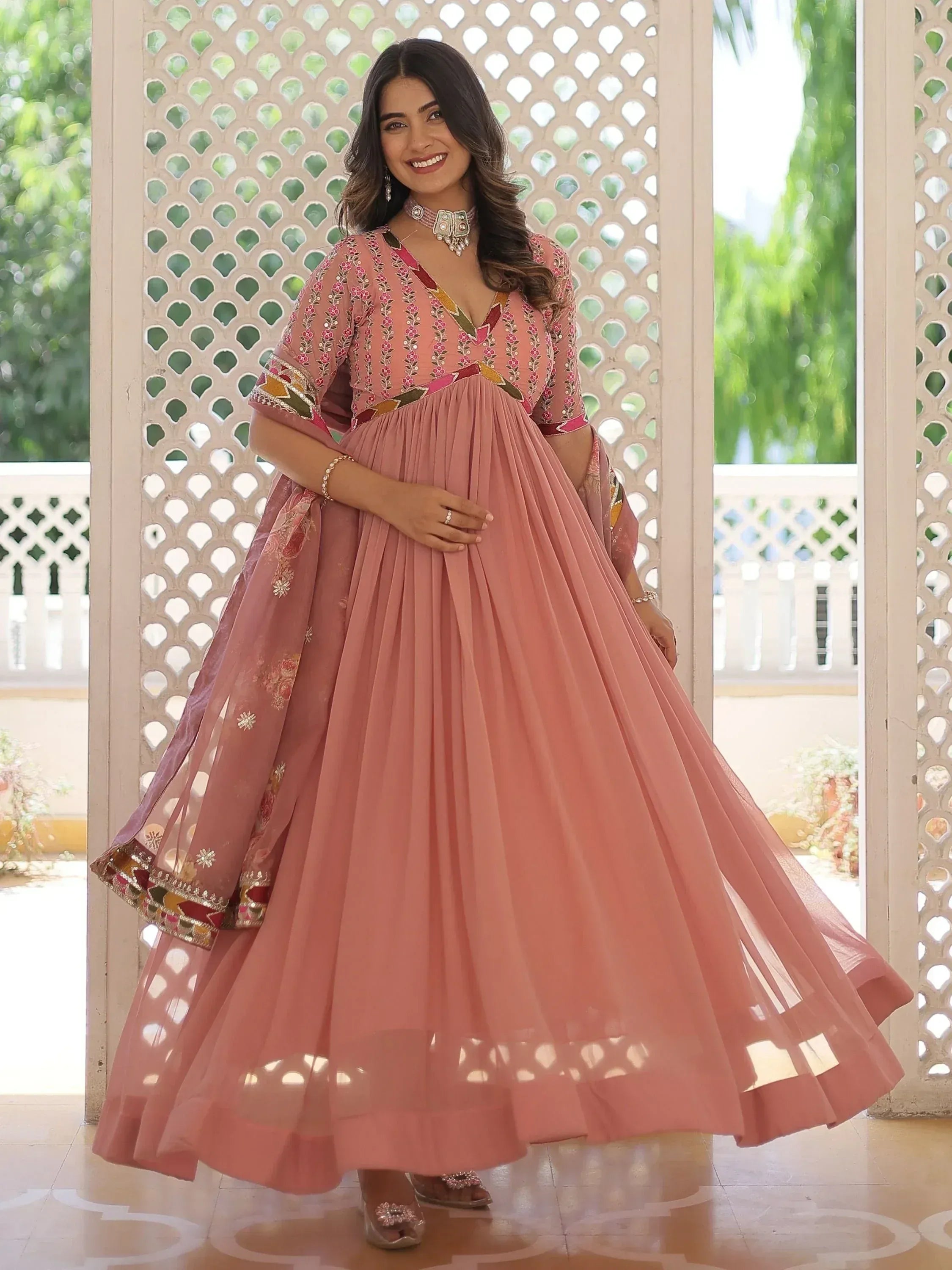 Pink embroidered lehenga choli with floral motifs and pleated skirt, perfect for Indian ethnic occasions
