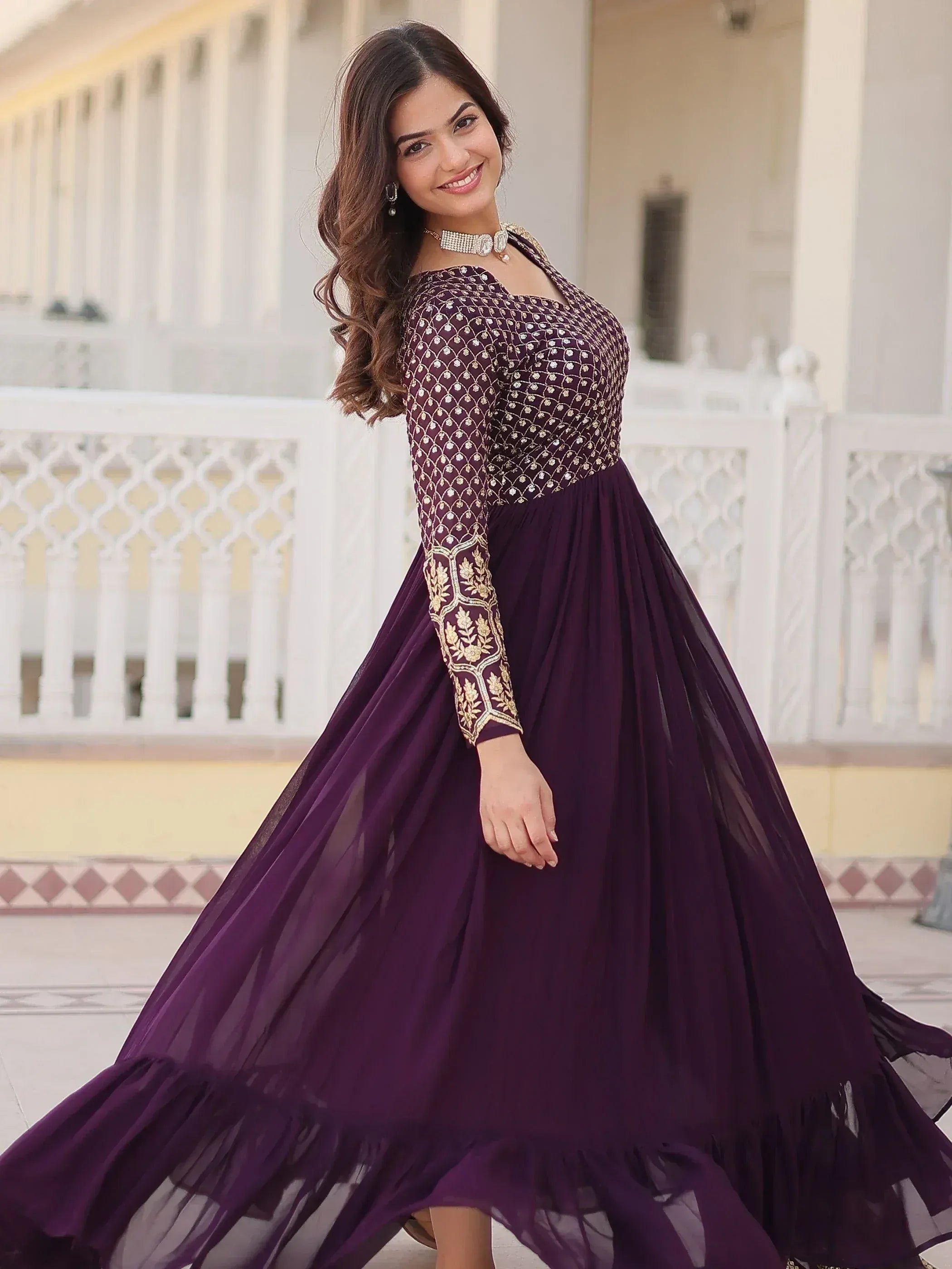 Elegant purple ethnic gown with gold embroidery, perfect for Indian weddings and festive occasions.