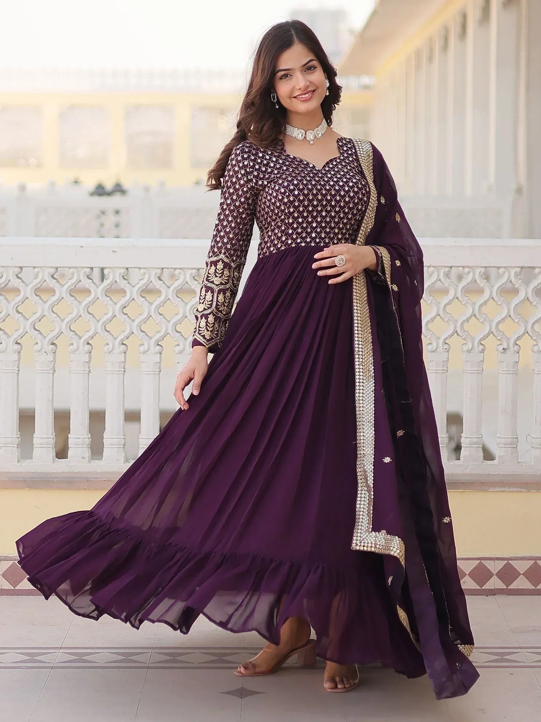 Elegant purple ethnic gown with gold embroidery, perfect for Indian occasions and festive wear.