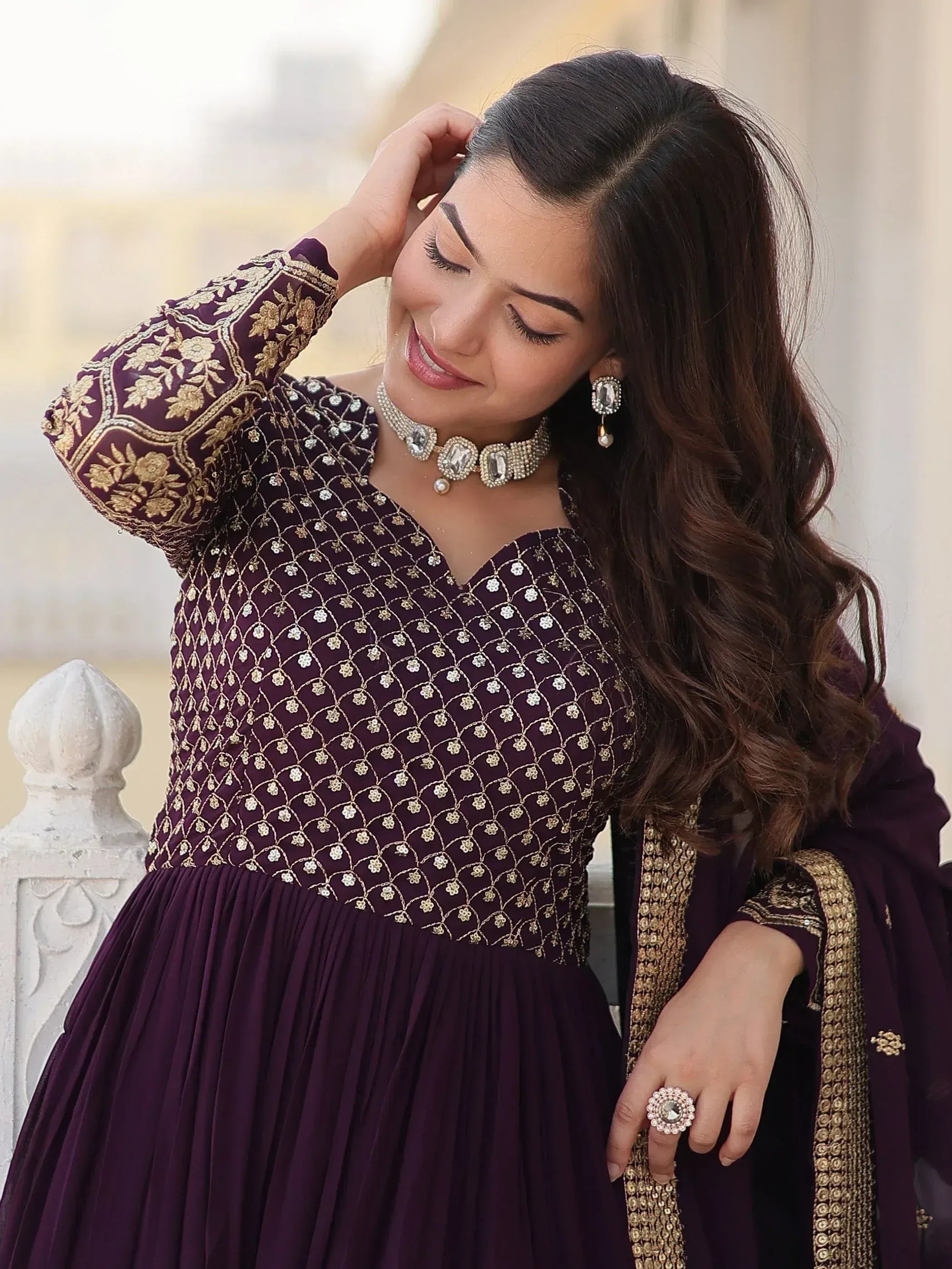 Elegant purple ethnic gown with gold embroidery, perfect for Indian weddings or festive occasions.