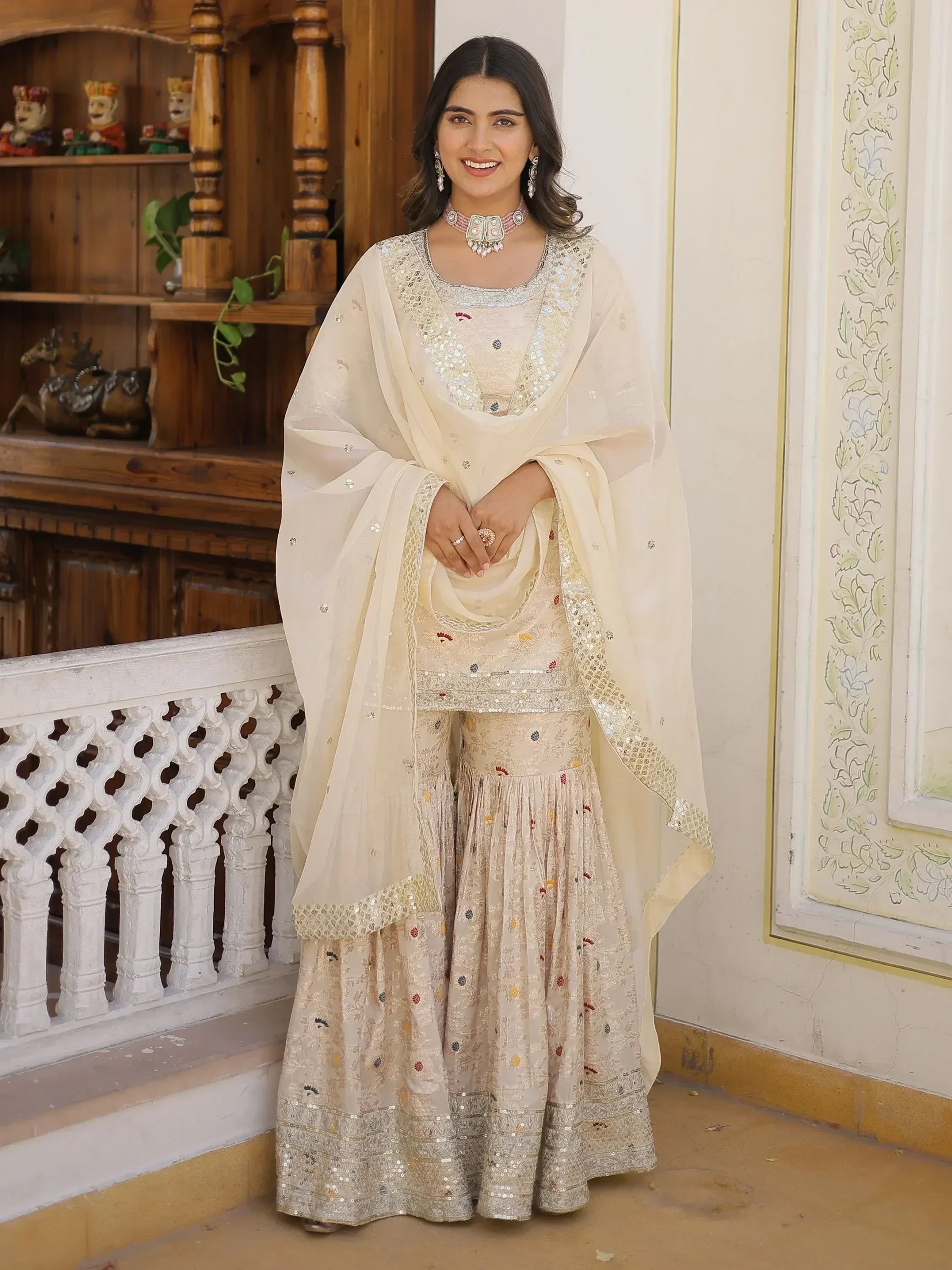 Elegant cream ethnic wear with sequin embroidery, perfect for Indian celebrations and weddings.