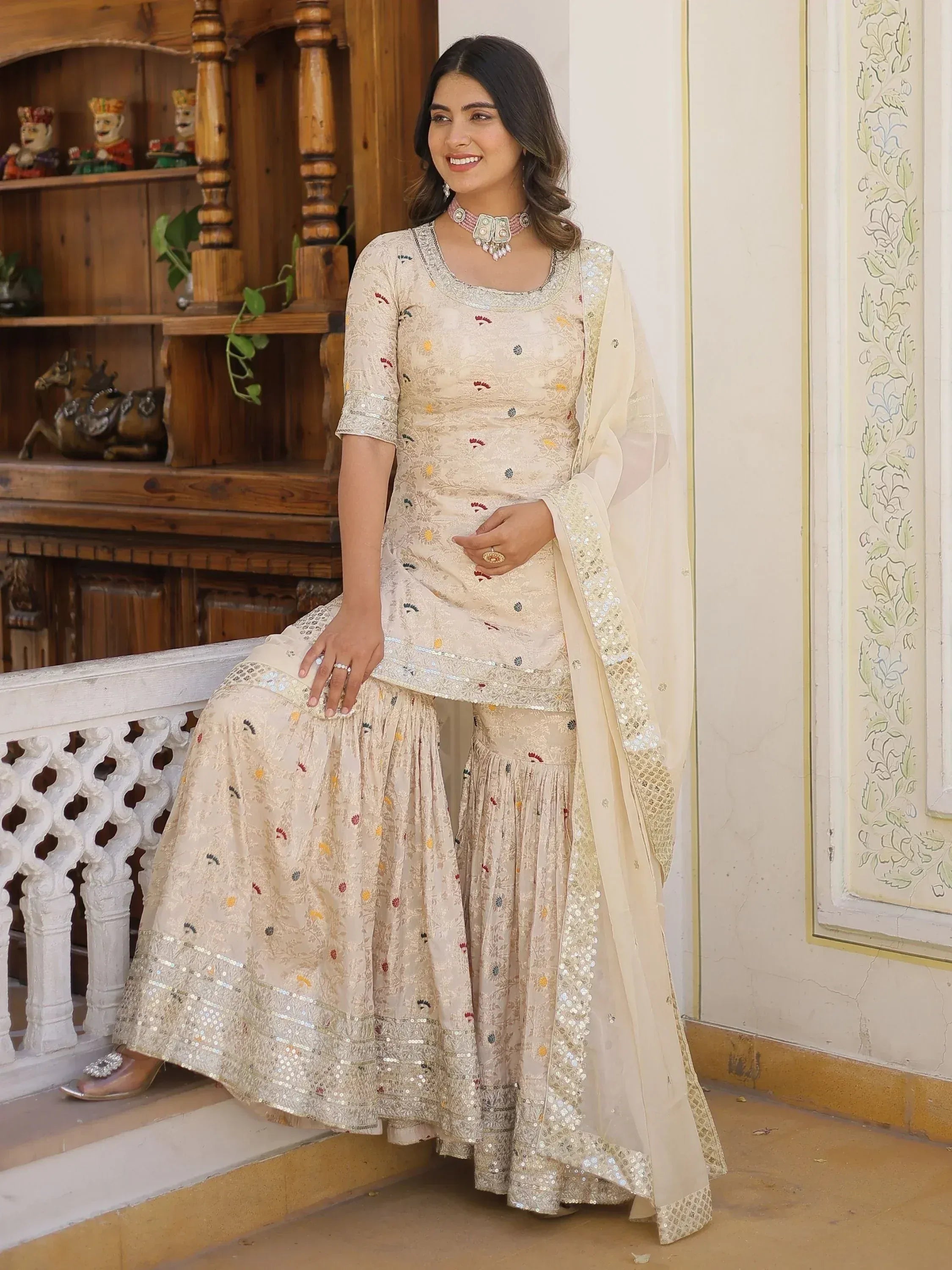 Elegant cream embroidered sharara suit with sequin detailing, perfect for Indian ethnic occasions