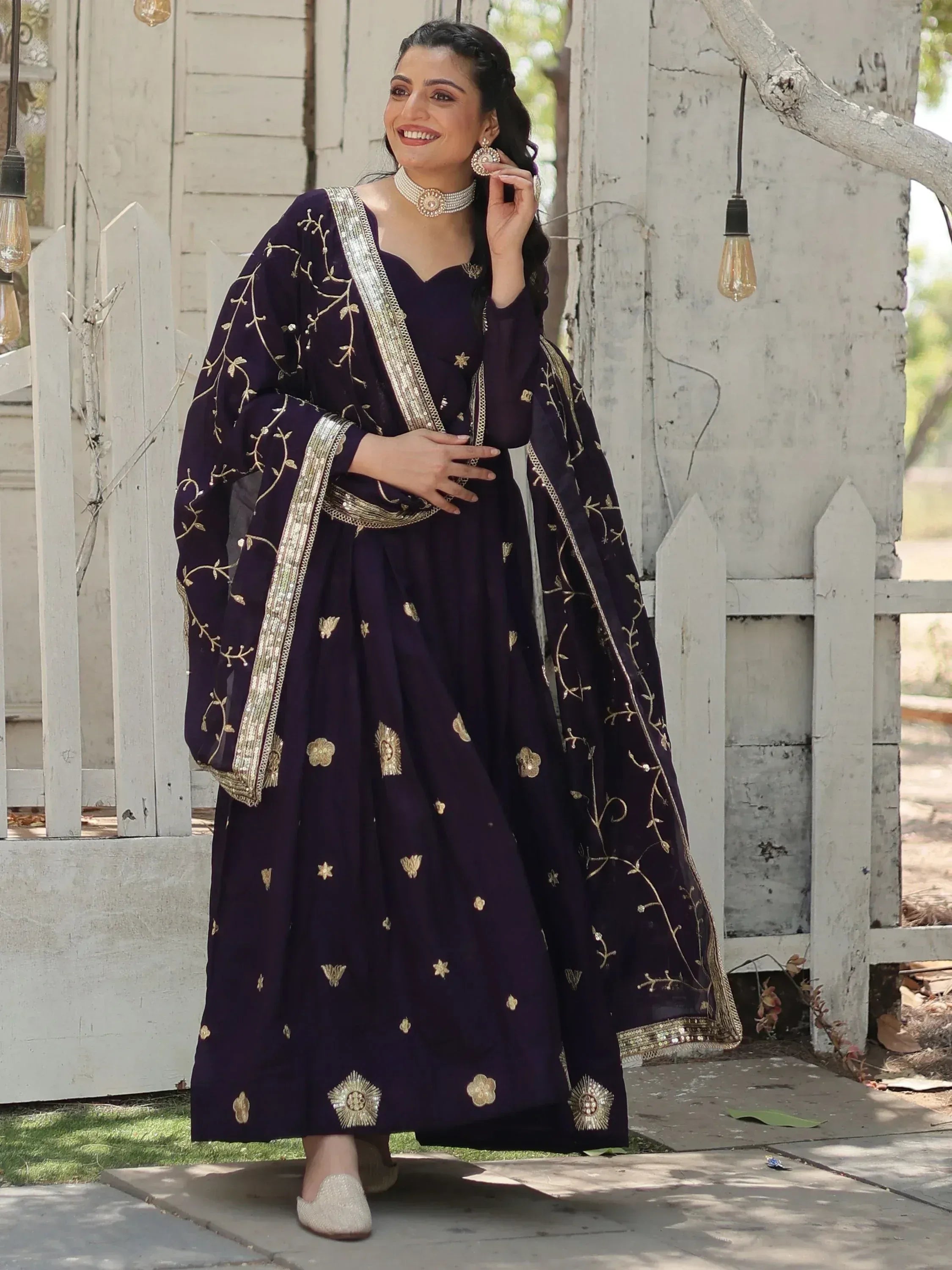 Elegant purple Indian anarkali suit with gold embroidery, perfect for weddings and festive occasions.