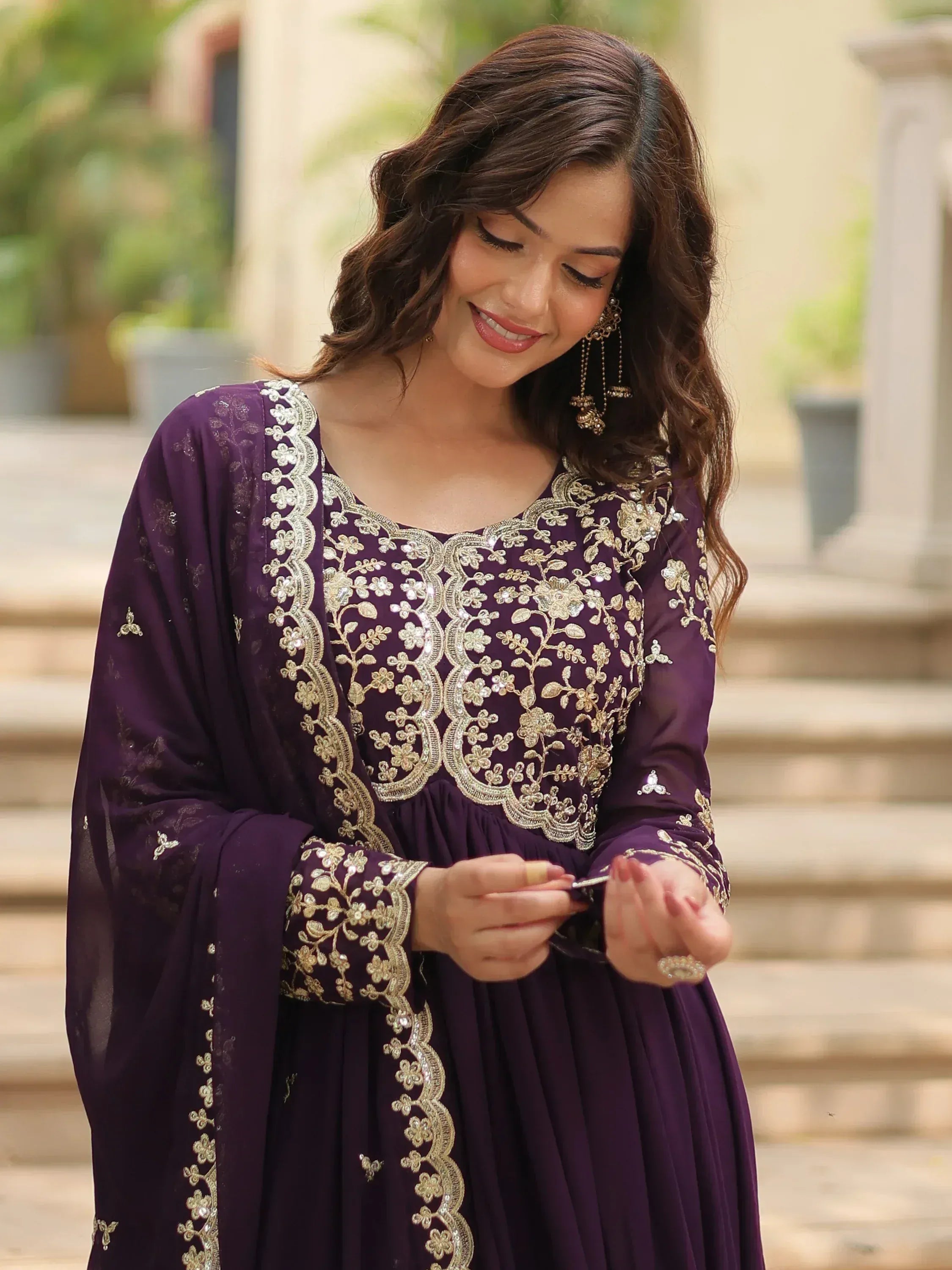 Purple ethnic gown with gold floral embroidery, perfect for Indian occasions and festive wear.