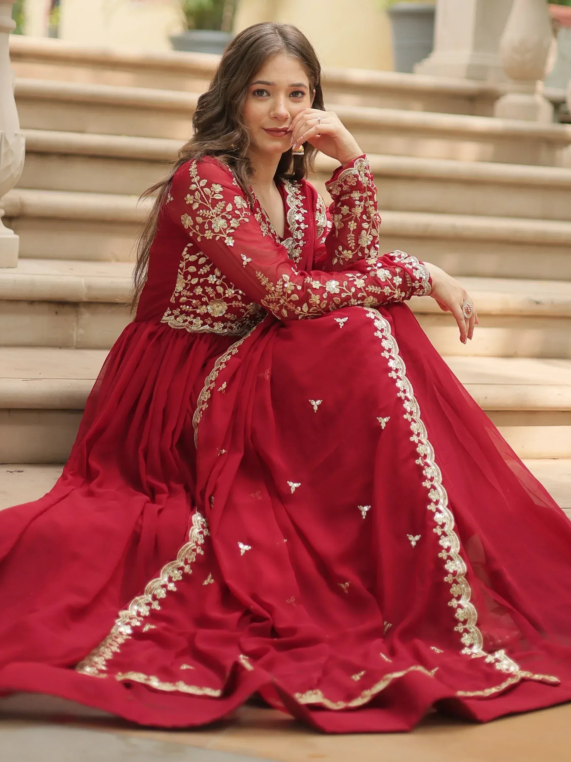 Red ethnic gown with gold embroidery, perfect for Indian weddings and festive occasions