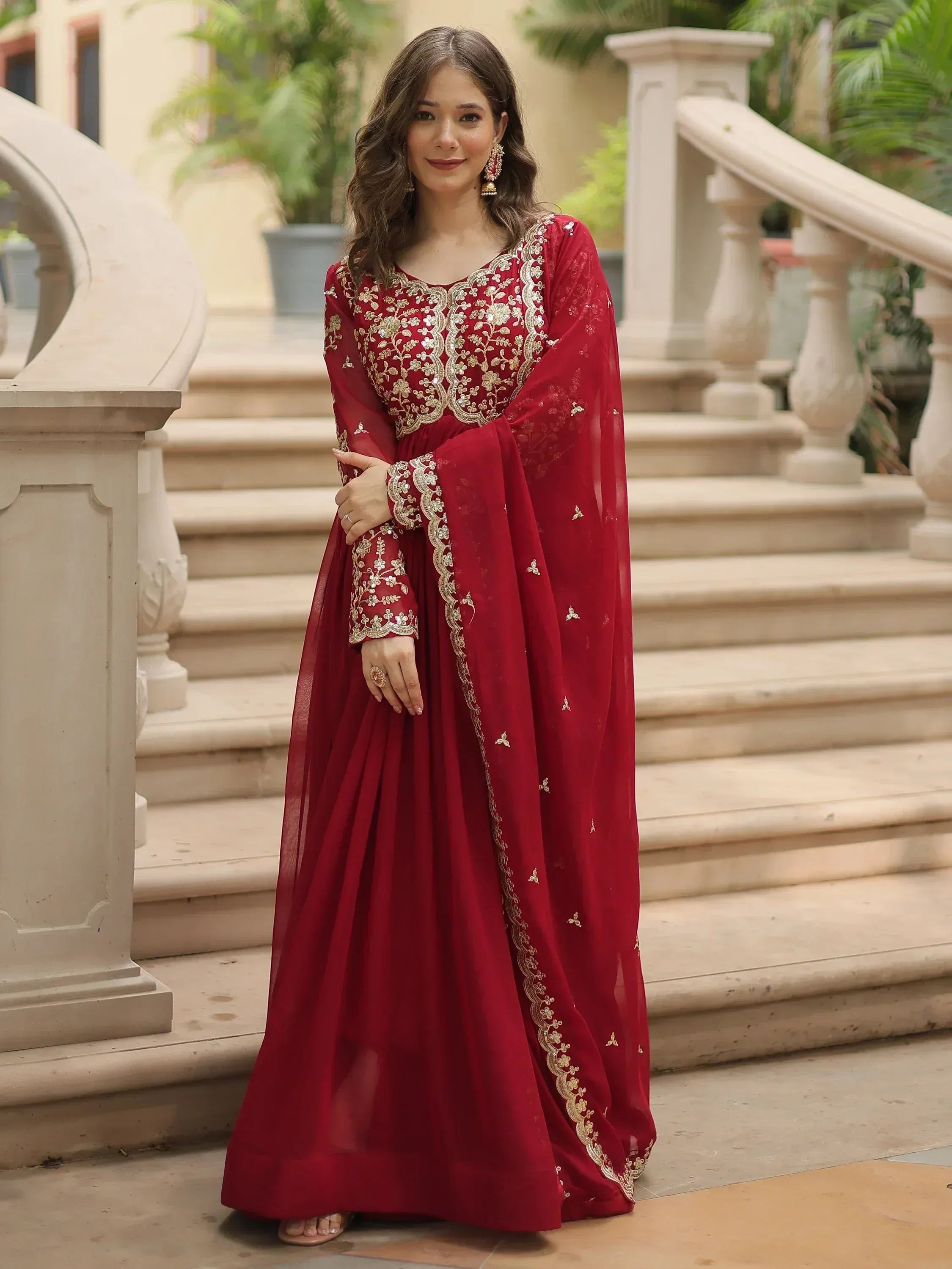 Red embroidered ethnic gown with gold detailing, perfect for Indian occasions and festive wear.