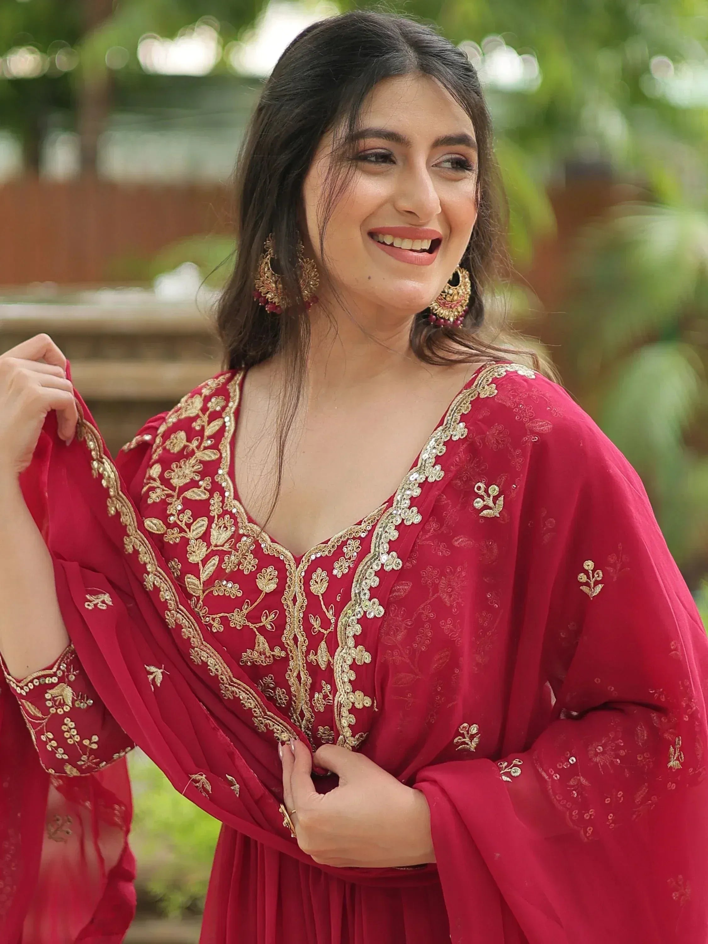 Red ethnic gown with gold embroidery, perfect for festive occasions