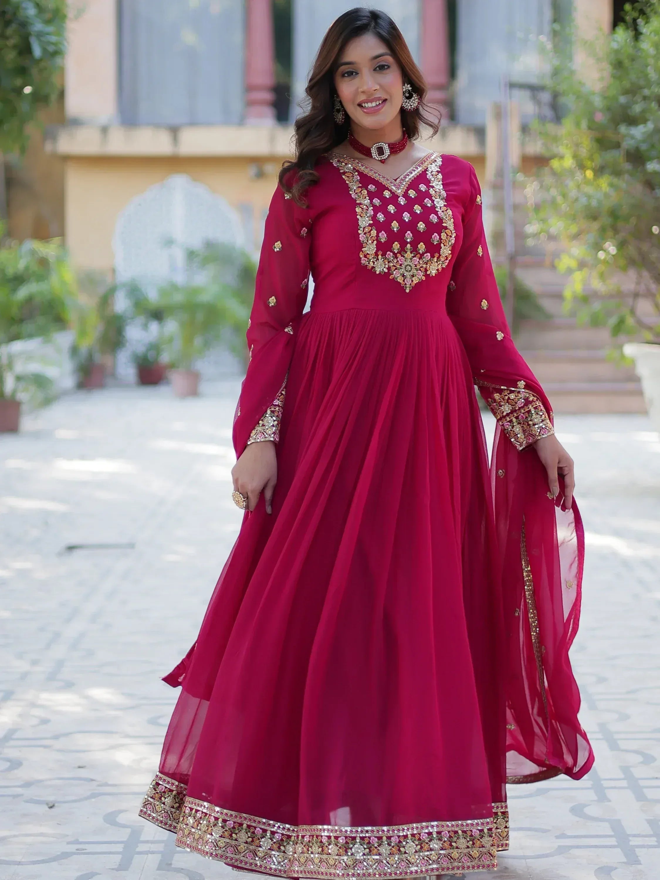 Red embroidered ethnic gown with floral embellishments, perfect for Indian celebrations and festive occasions.