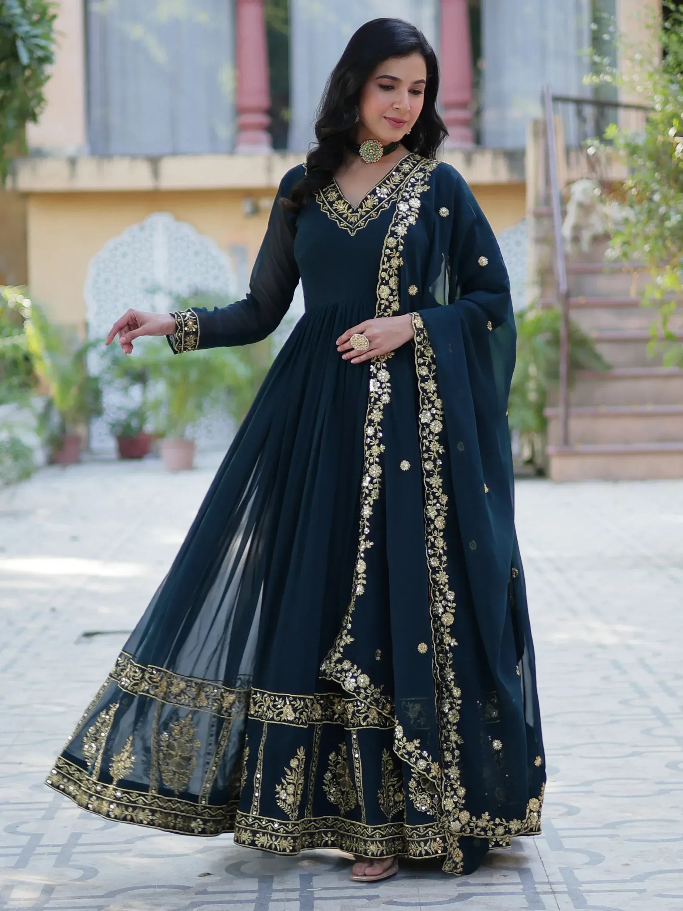 Elegant dark green ethnic gown with gold embroidery, perfect for Indian occasions and festive wear.