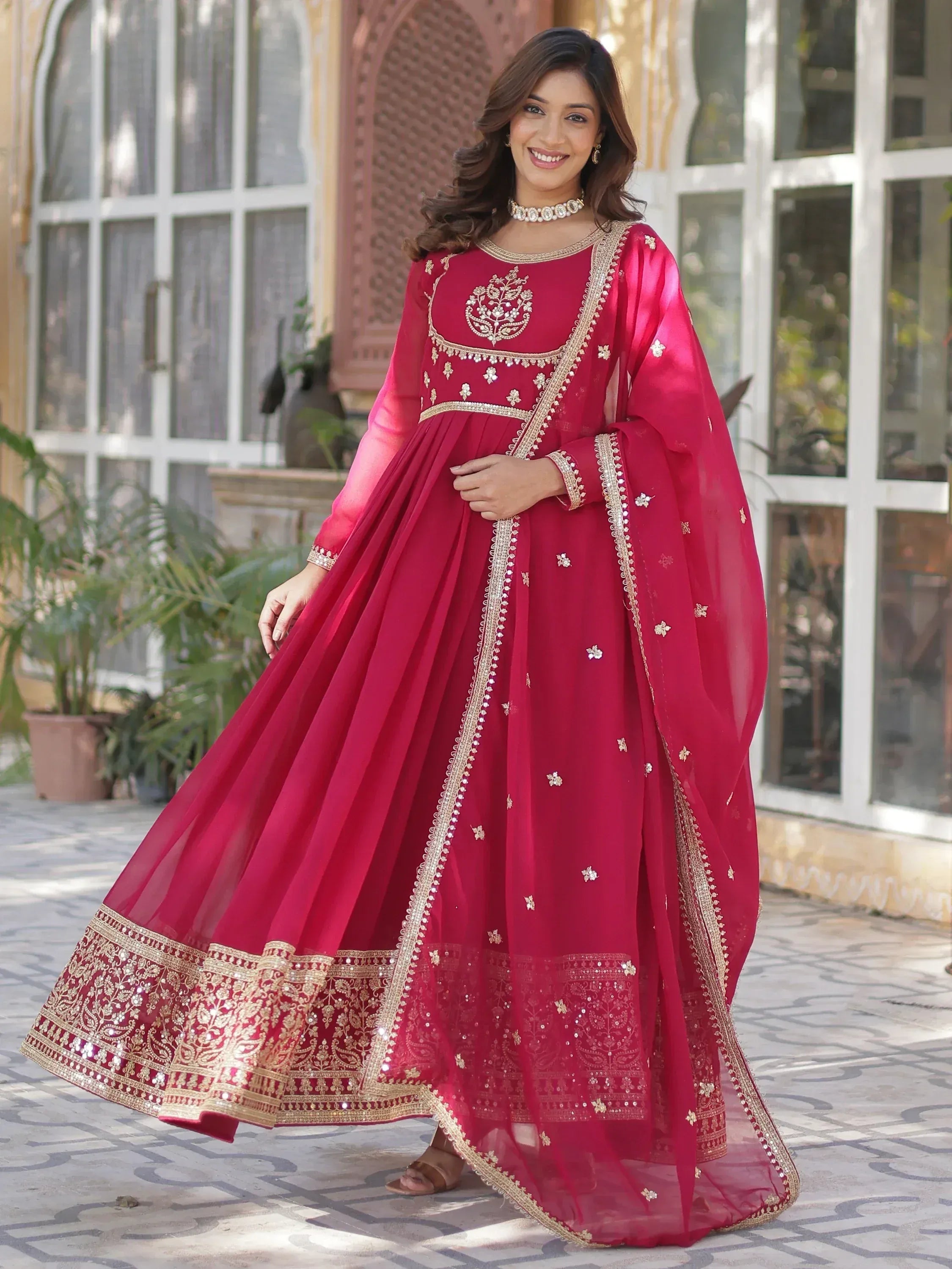Elegant maroon Indian anarkali with gold embroidery, perfect for weddings and festive occasions.