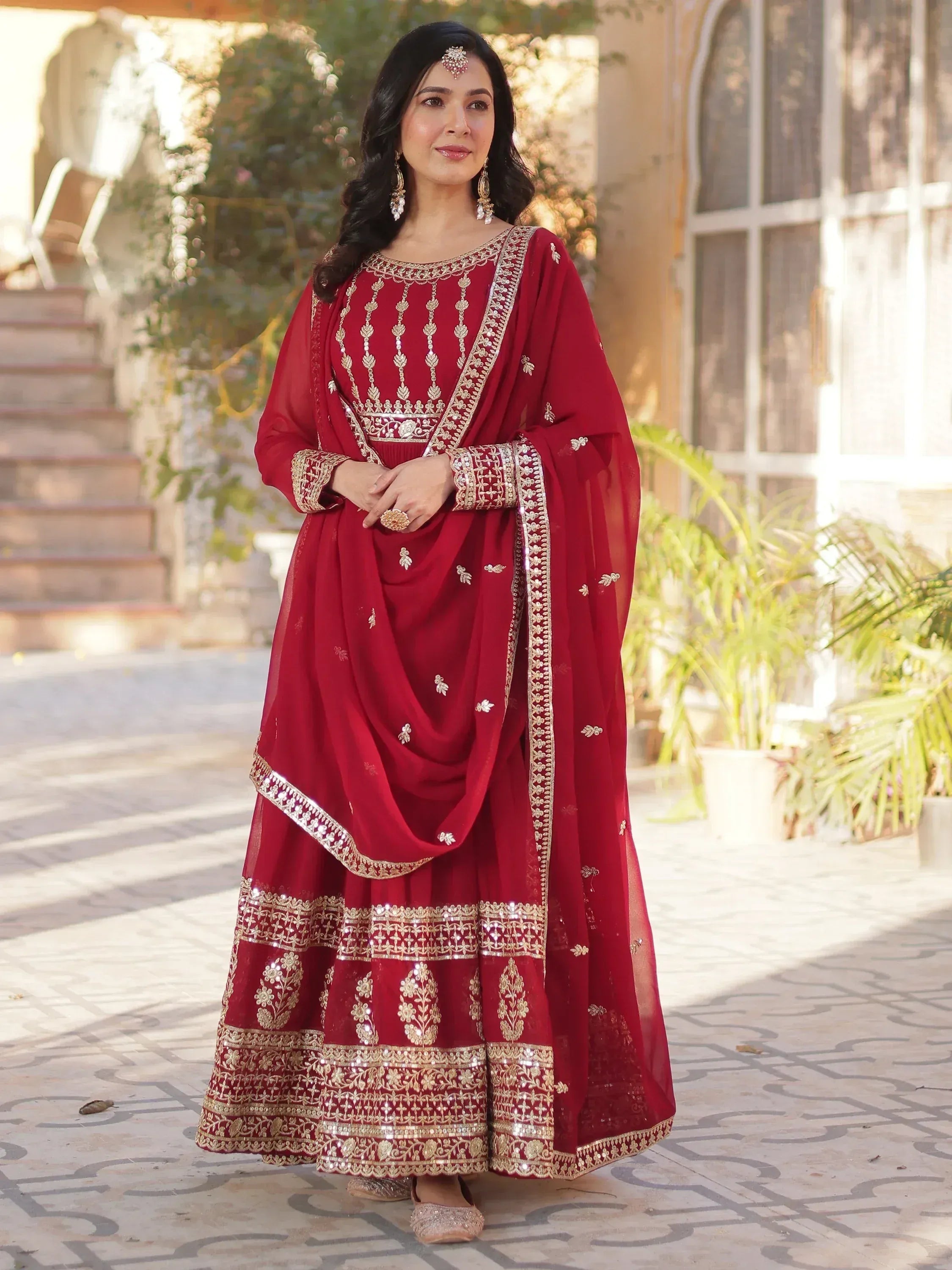 Elegant maroon Indian ethnic wear with gold embroidery, perfect for weddings and festive occasions.