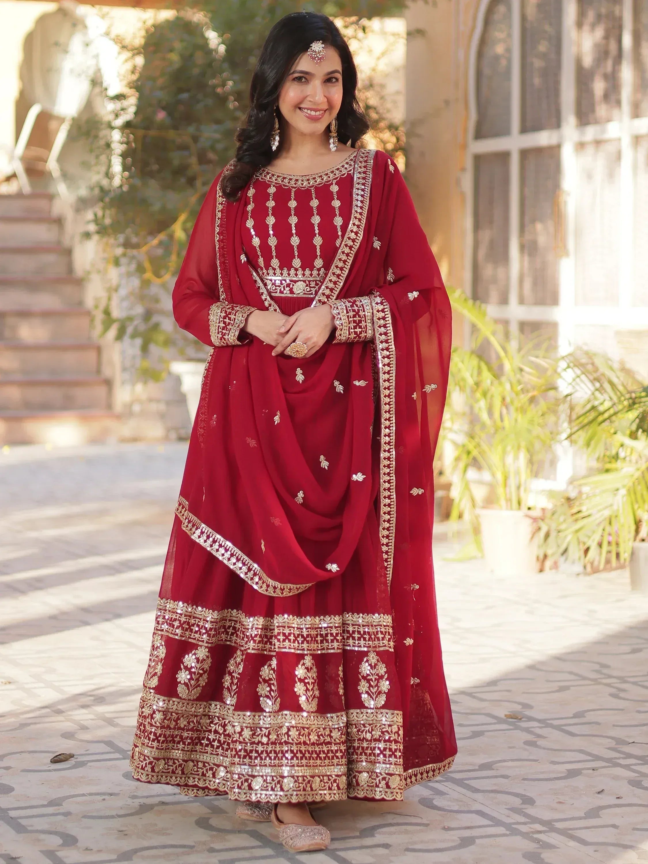 Elegant maroon Indian ethnic wear with gold embroidery, perfect for weddings and festive occasions.
