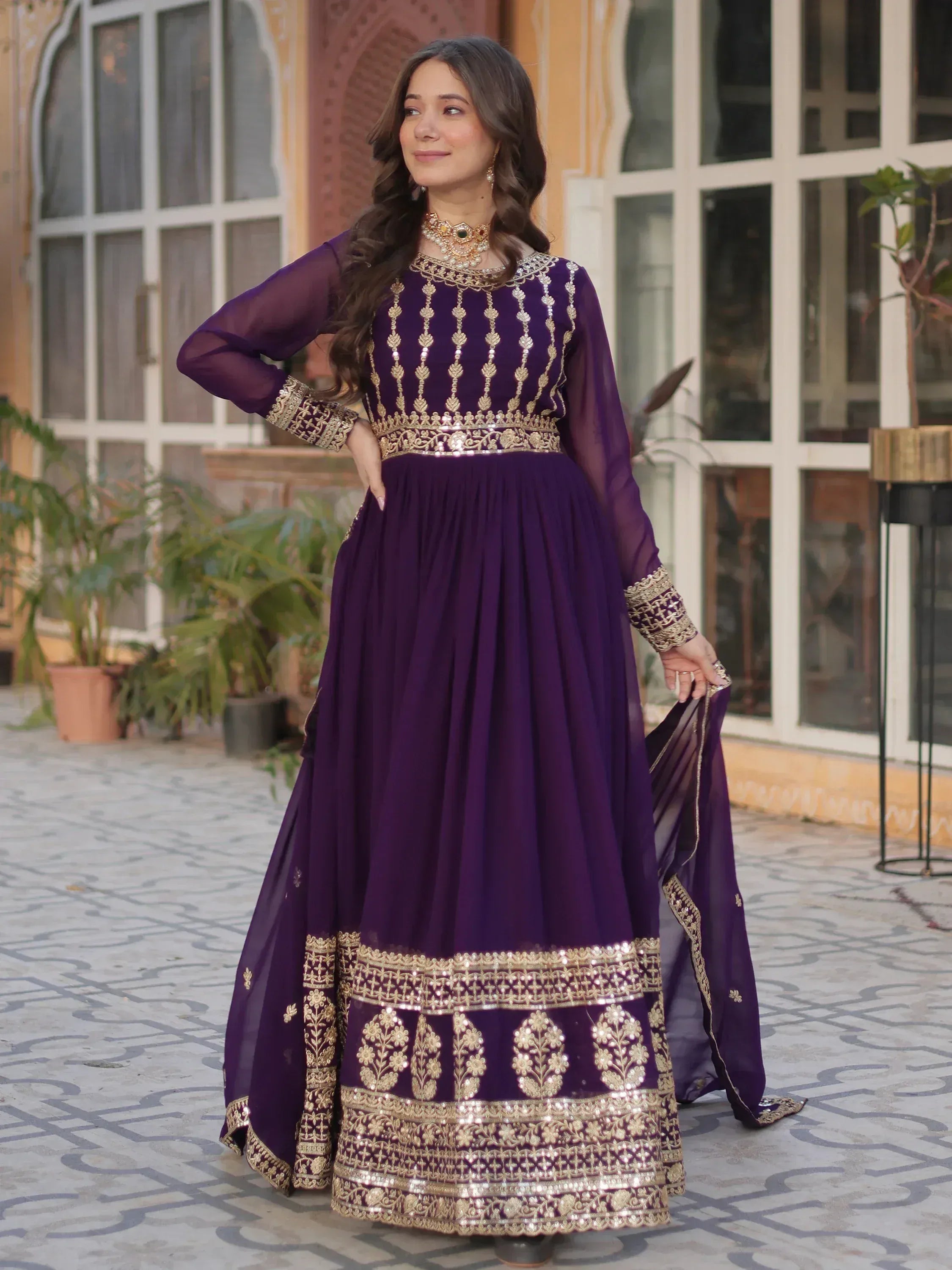 Purple ethnic gown with gold embroidery, perfect for Indian weddings or festive occasions.