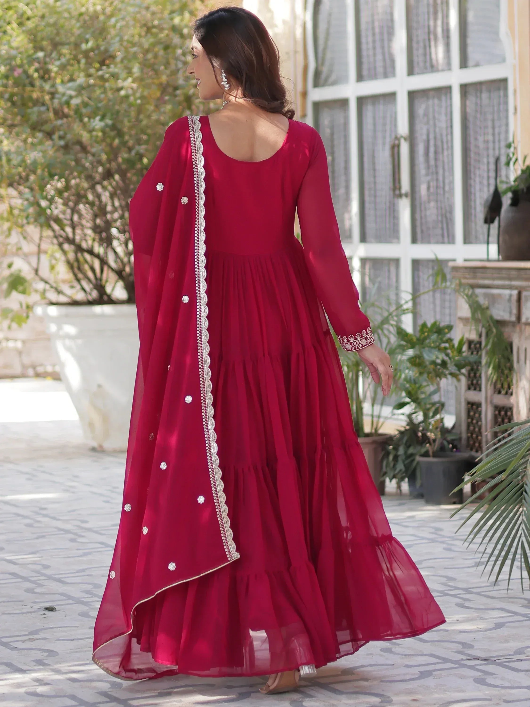 Elegant maroon ethnic gown with white embroidery and tiered skirt, perfect for festive occasions.