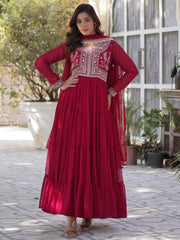 Woman in a pink designer ethnic gown with embroidery, outdoor setting at Ethnic Plus