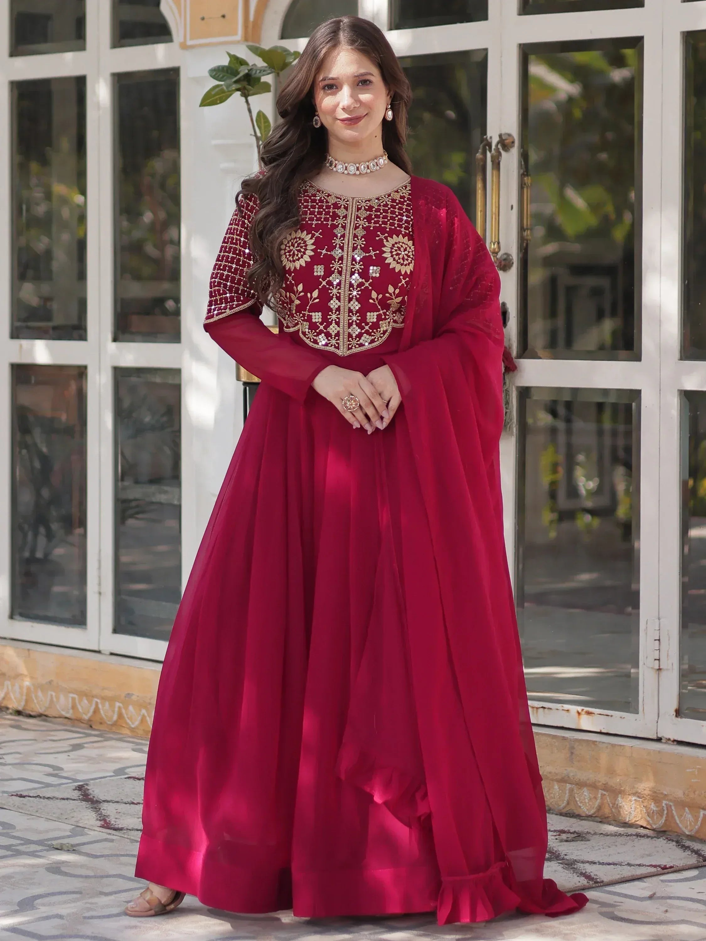 Elegant maroon ethnic gown with gold embroidery, perfect for Indian celebrations